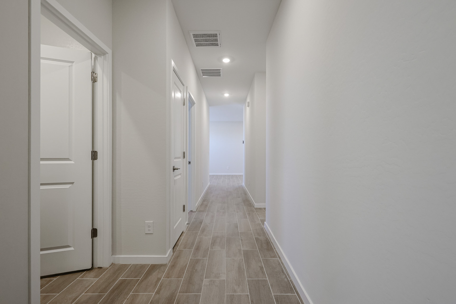 A hallway with white doors.