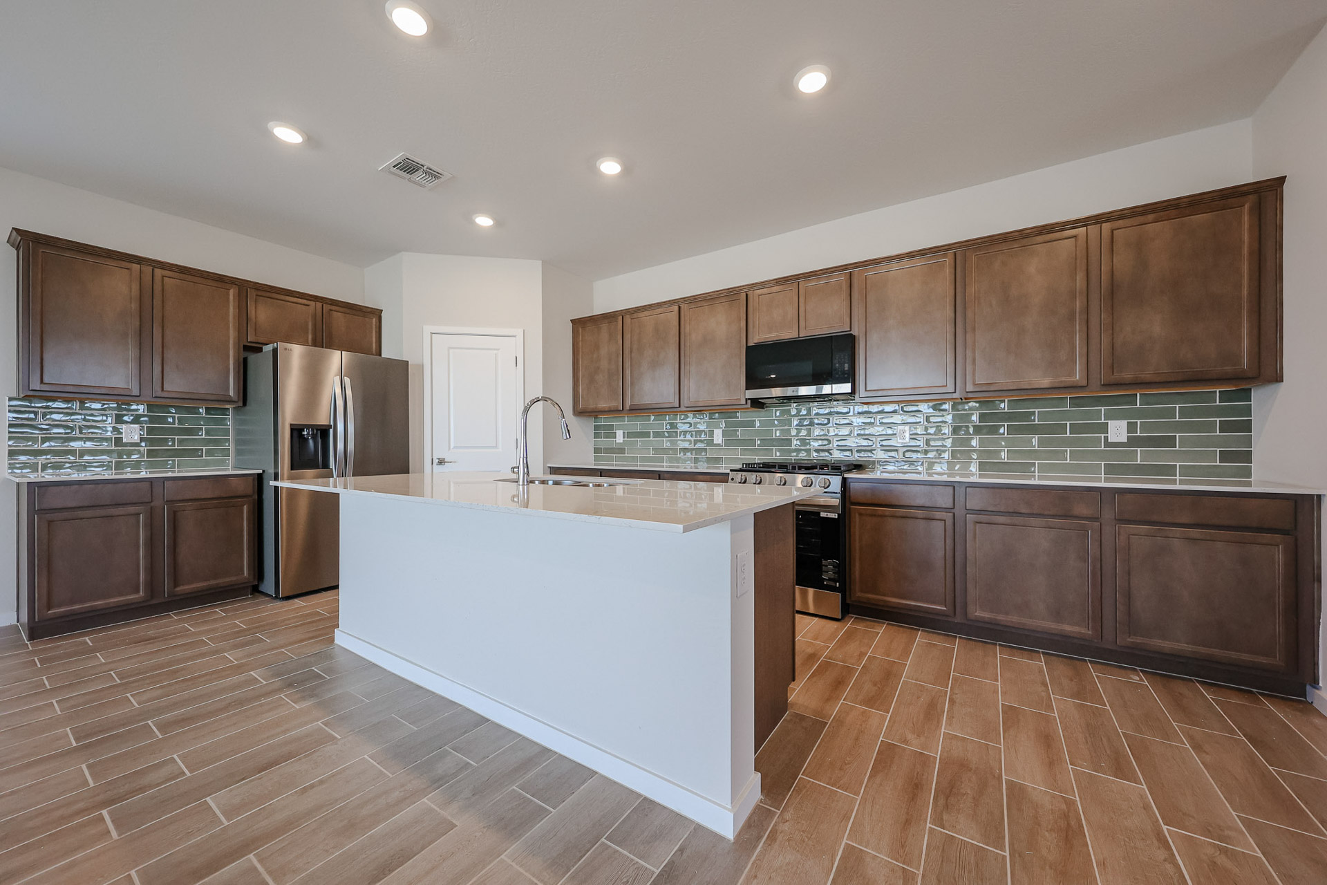 A kitchen with wooden cabinets.