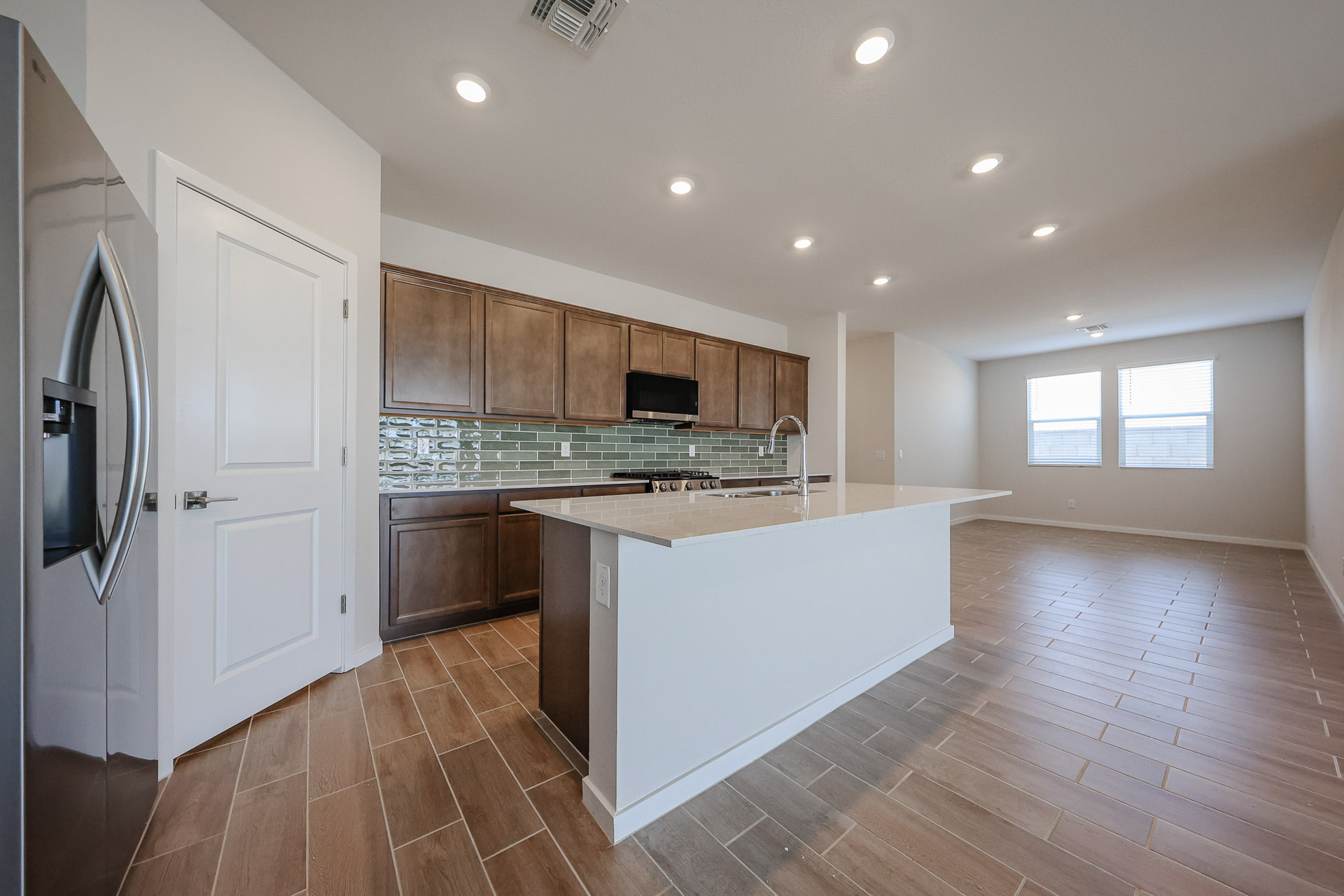 A kitchen with wooden cabinets.