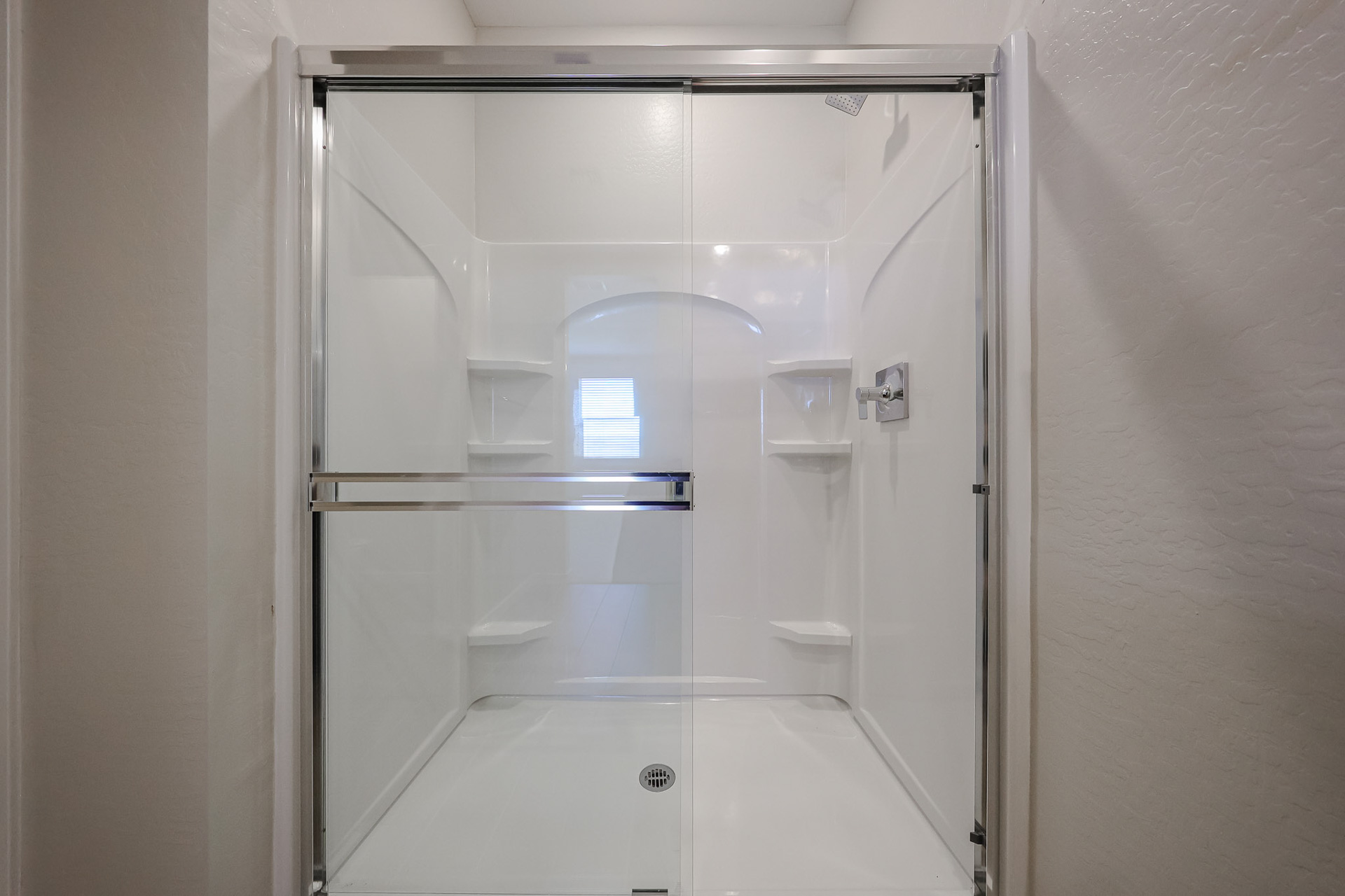 A shower with glass doors.