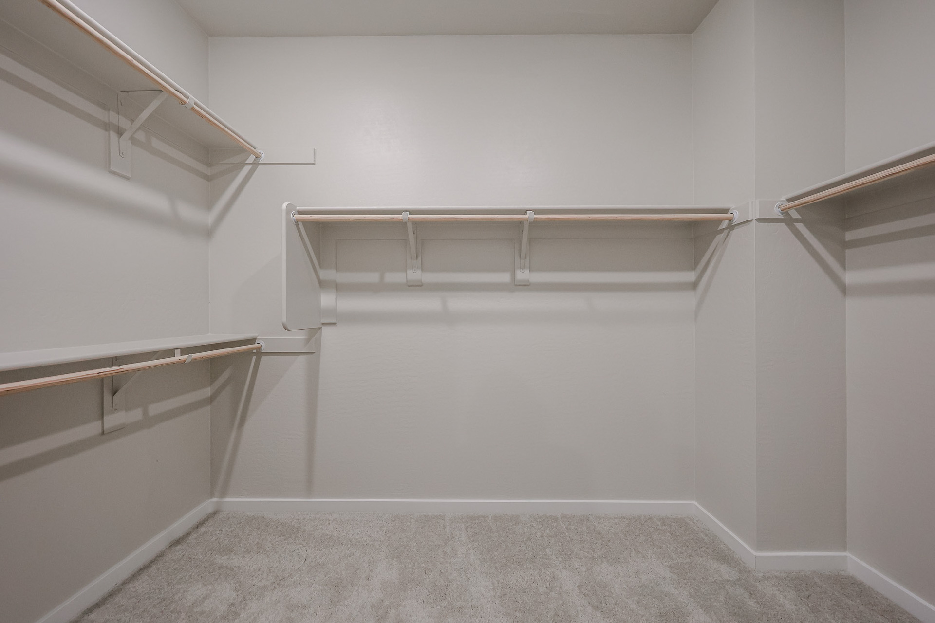 A white room with a metal railing.