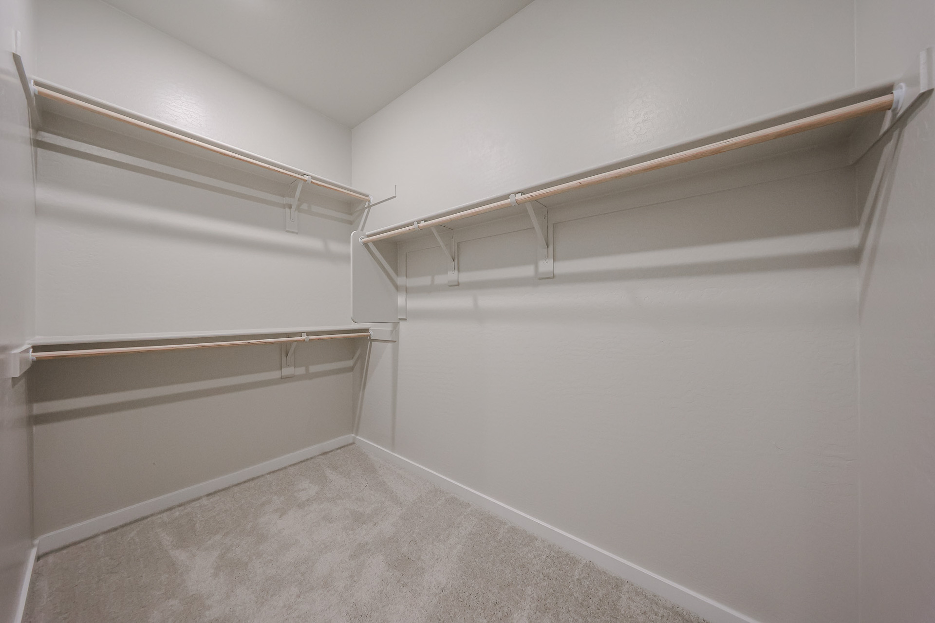 A white wall with a metal railing.