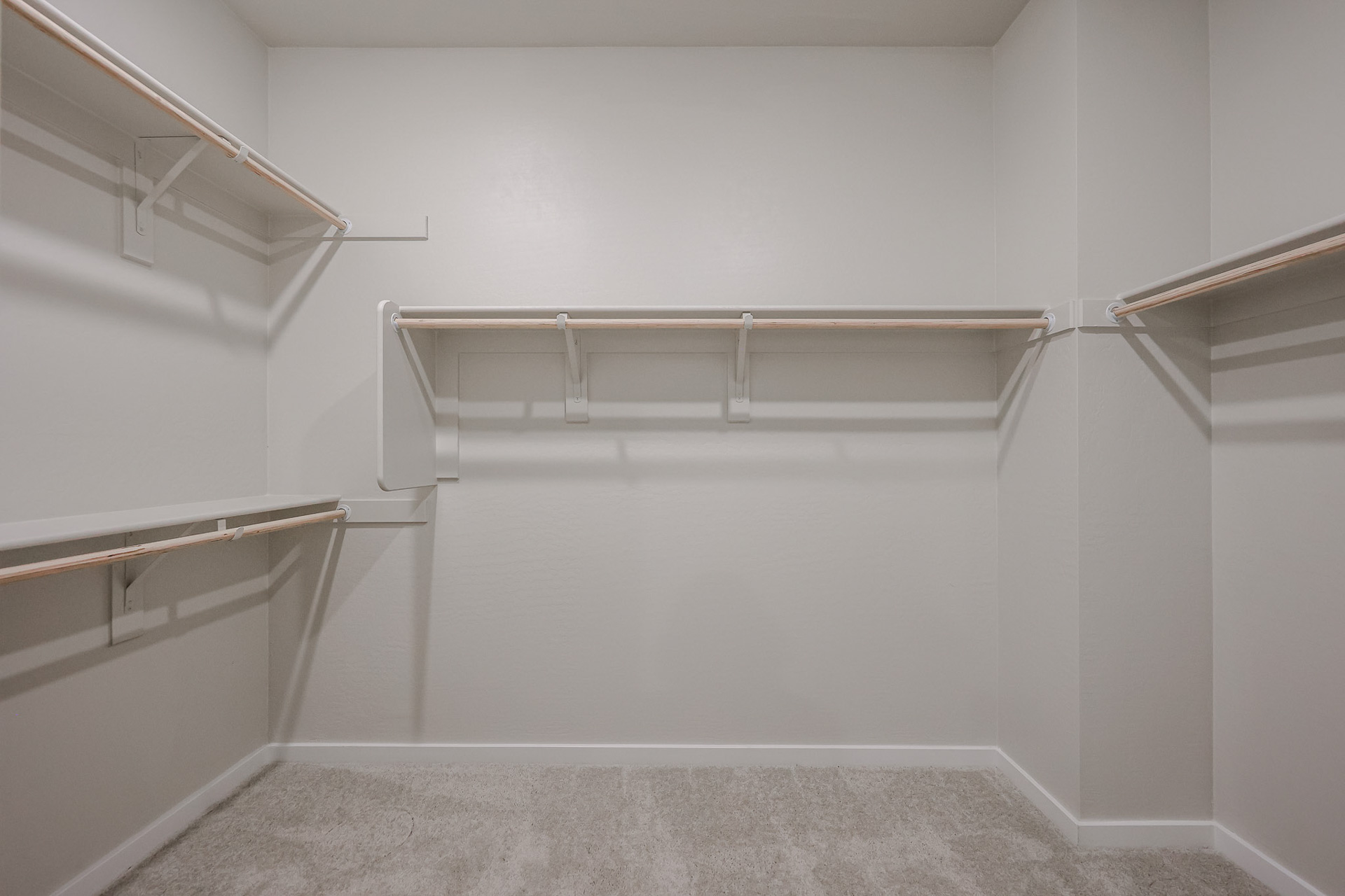 A white room with a metal railing.