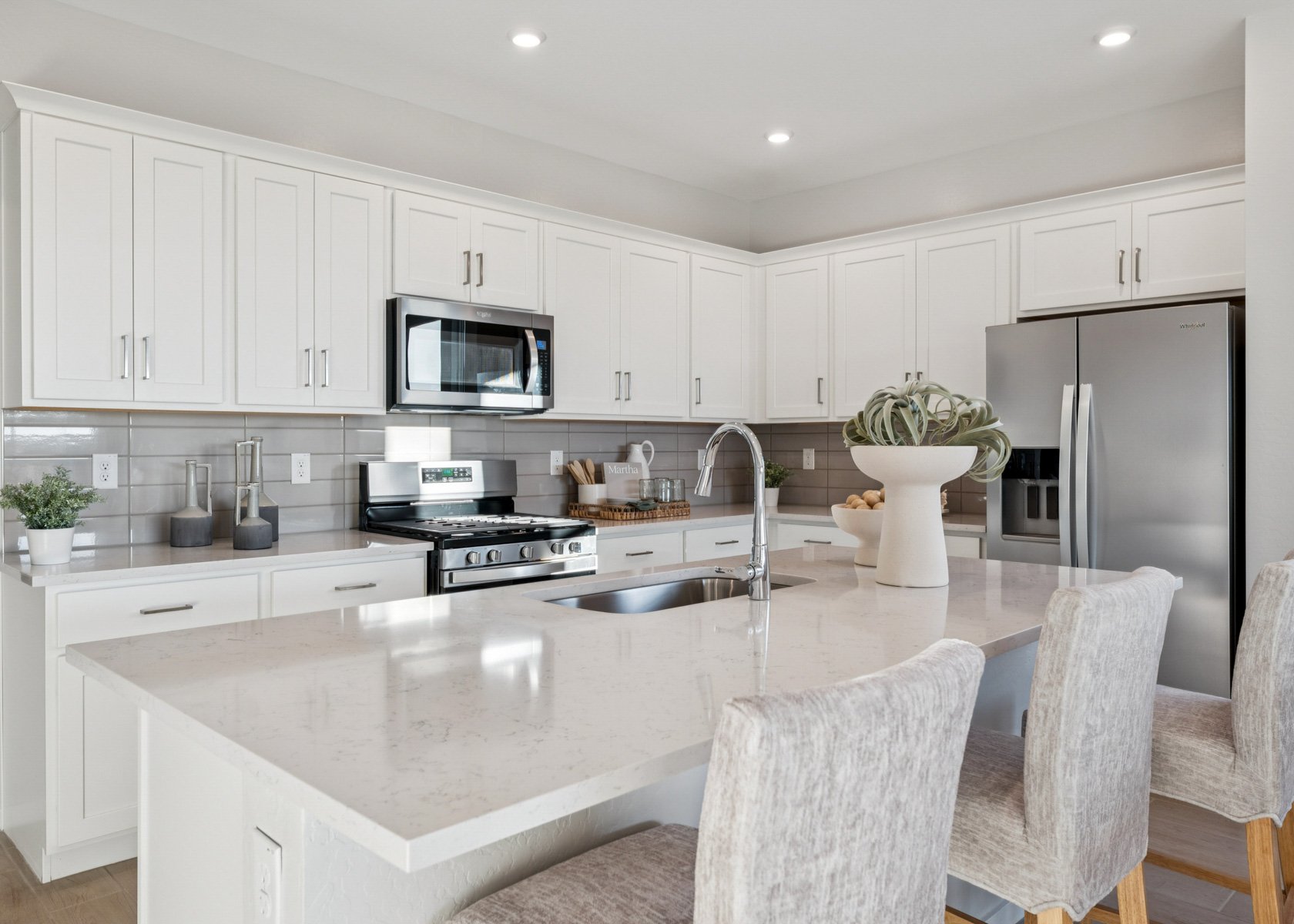 A kitchen with white cabinets.