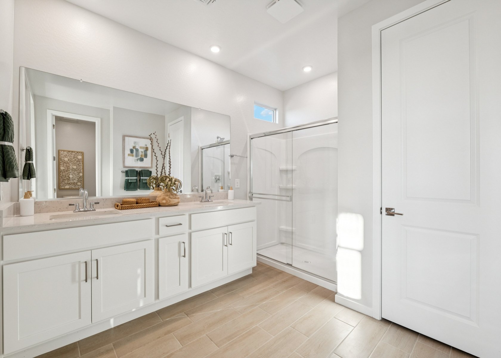 A bathroom with white cabinets.