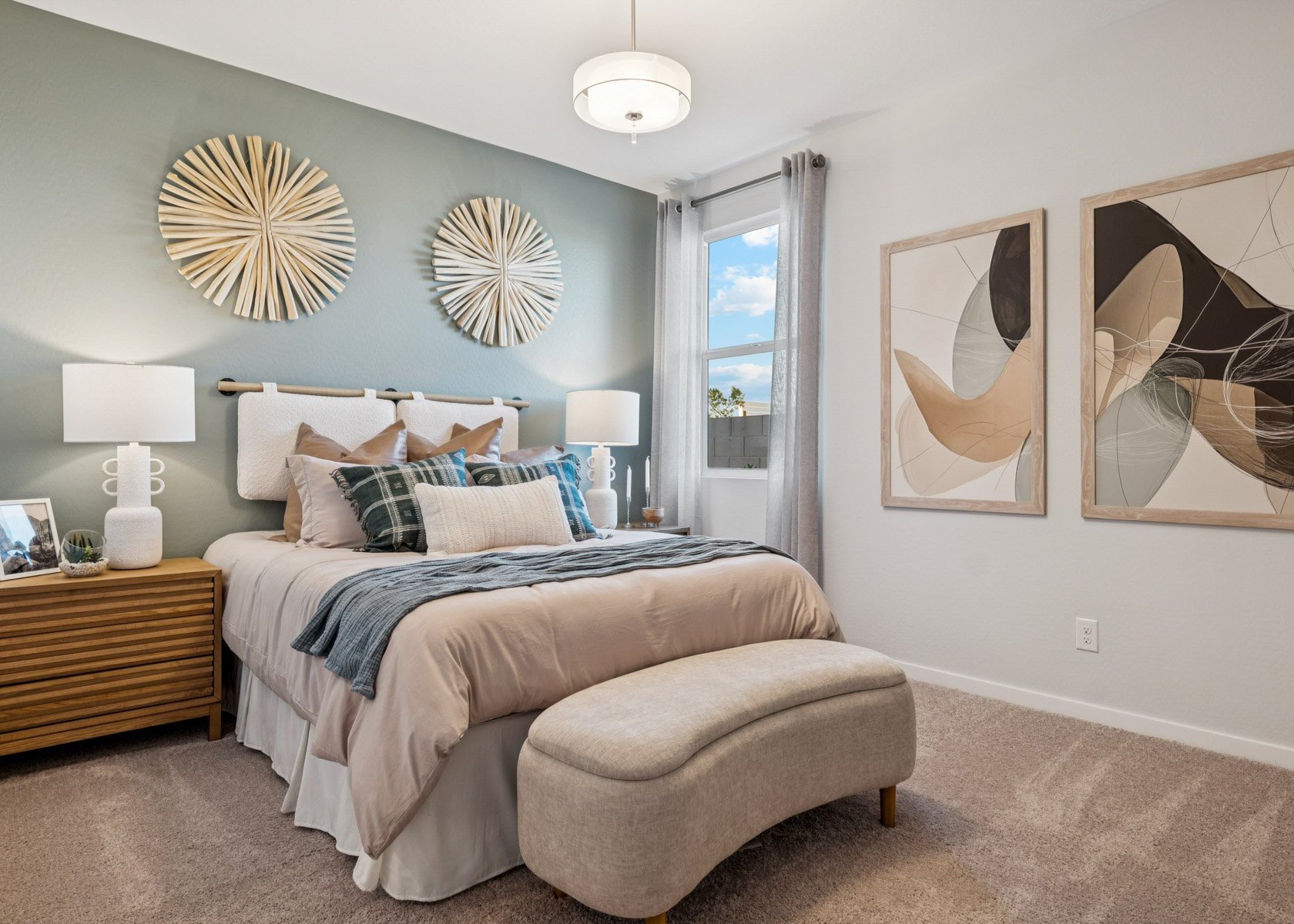 A bedroom with a bed and lamps.