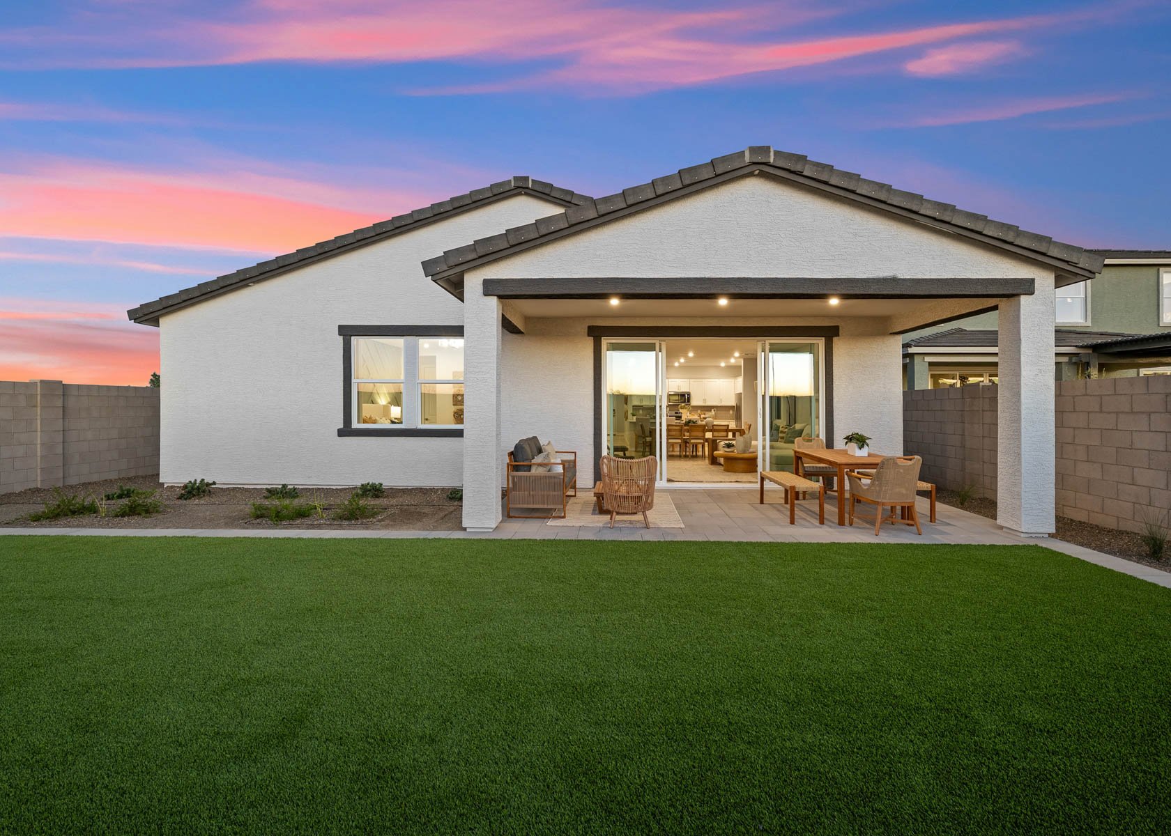 A house with a lawn and chairs.
