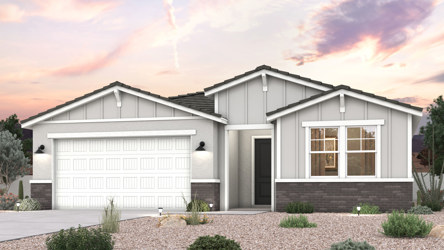 A house with desert landscape and a 2 car garage.