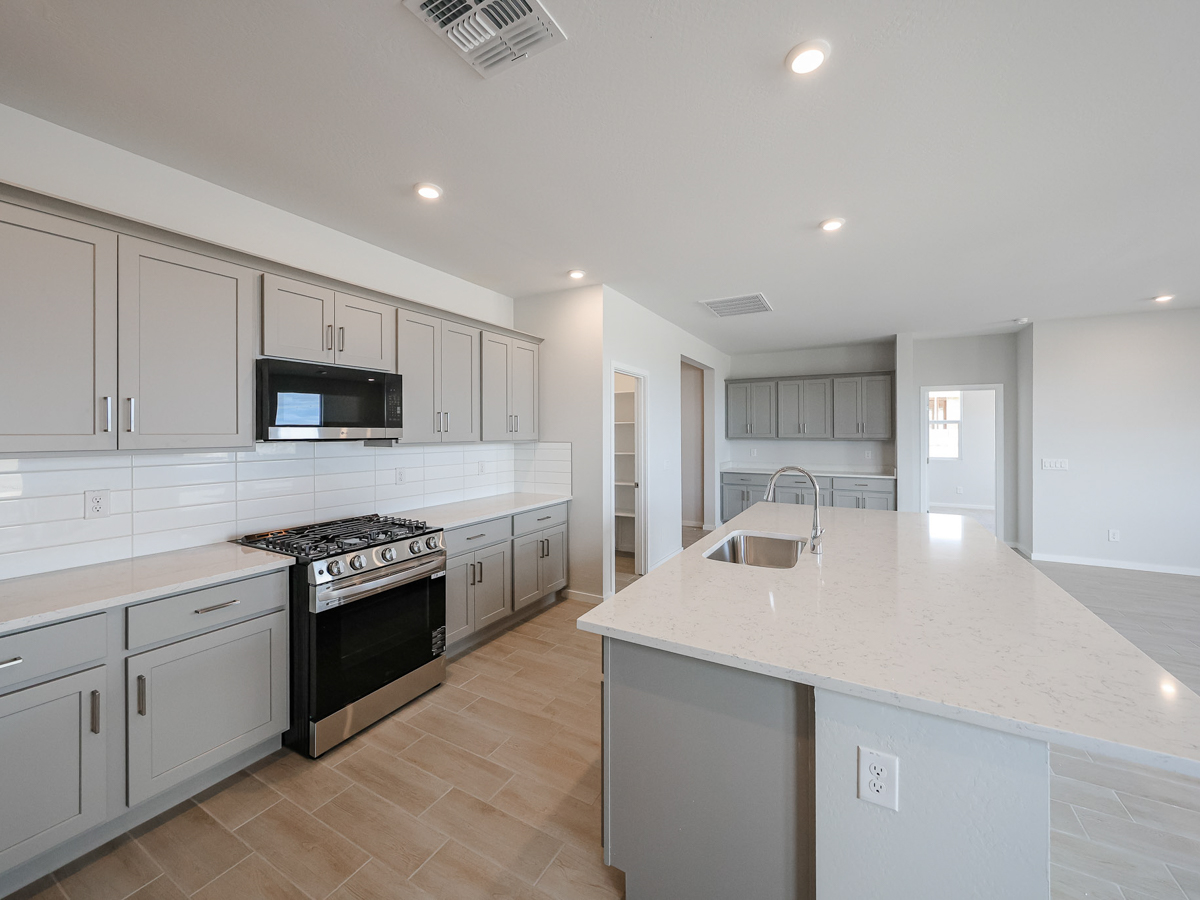 A kitchen with white cabinets.