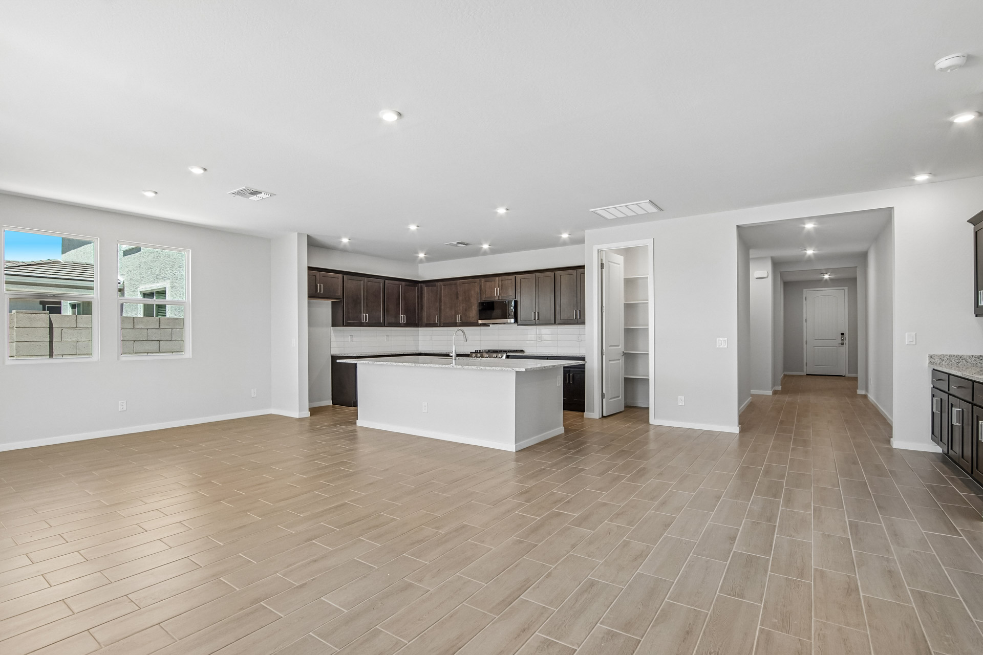 A large kitchen with a wood floor.