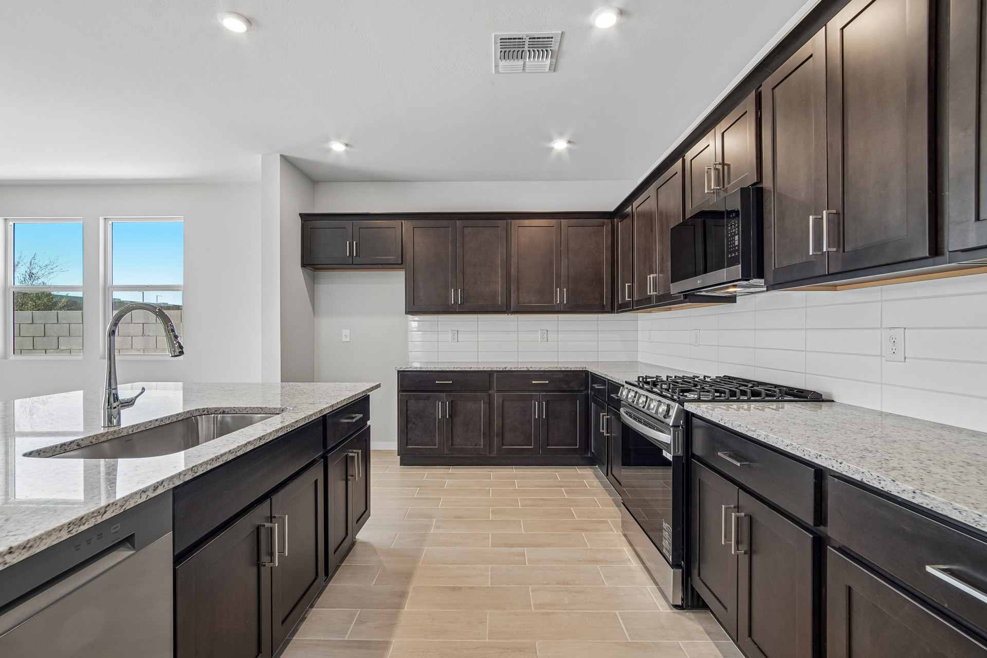A kitchen with black cabinets.
