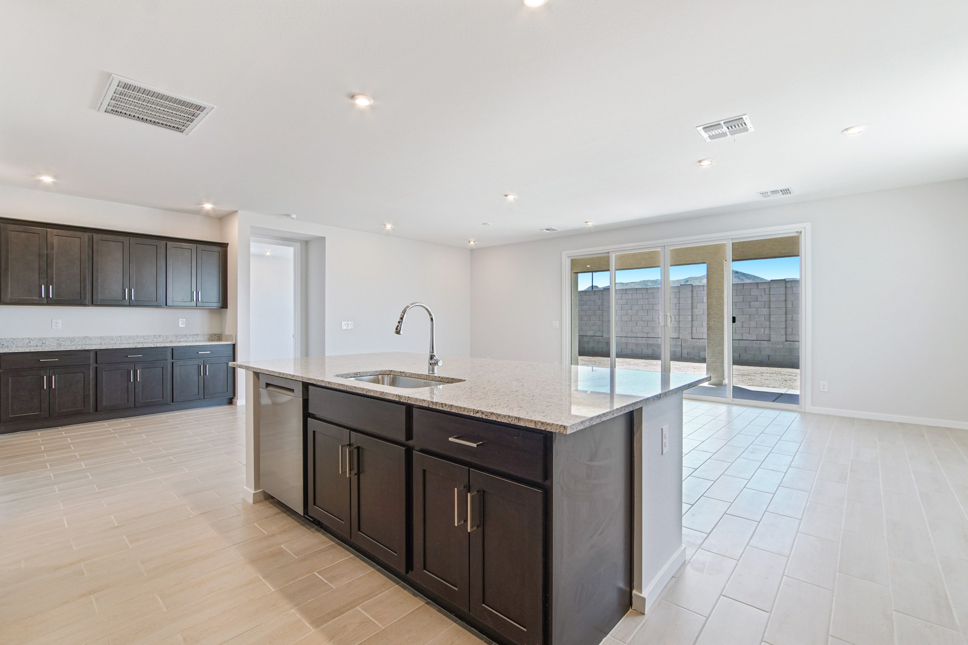 A kitchen with black cabinets.