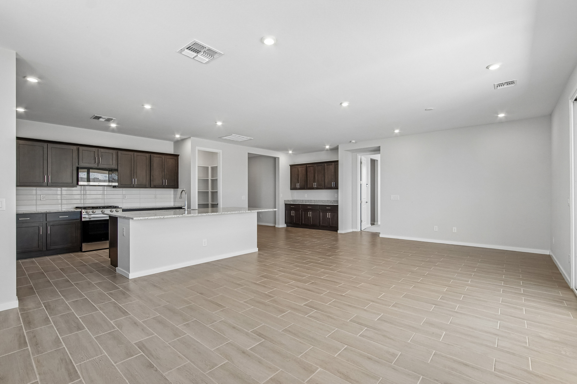 A large kitchen with wooden floors.