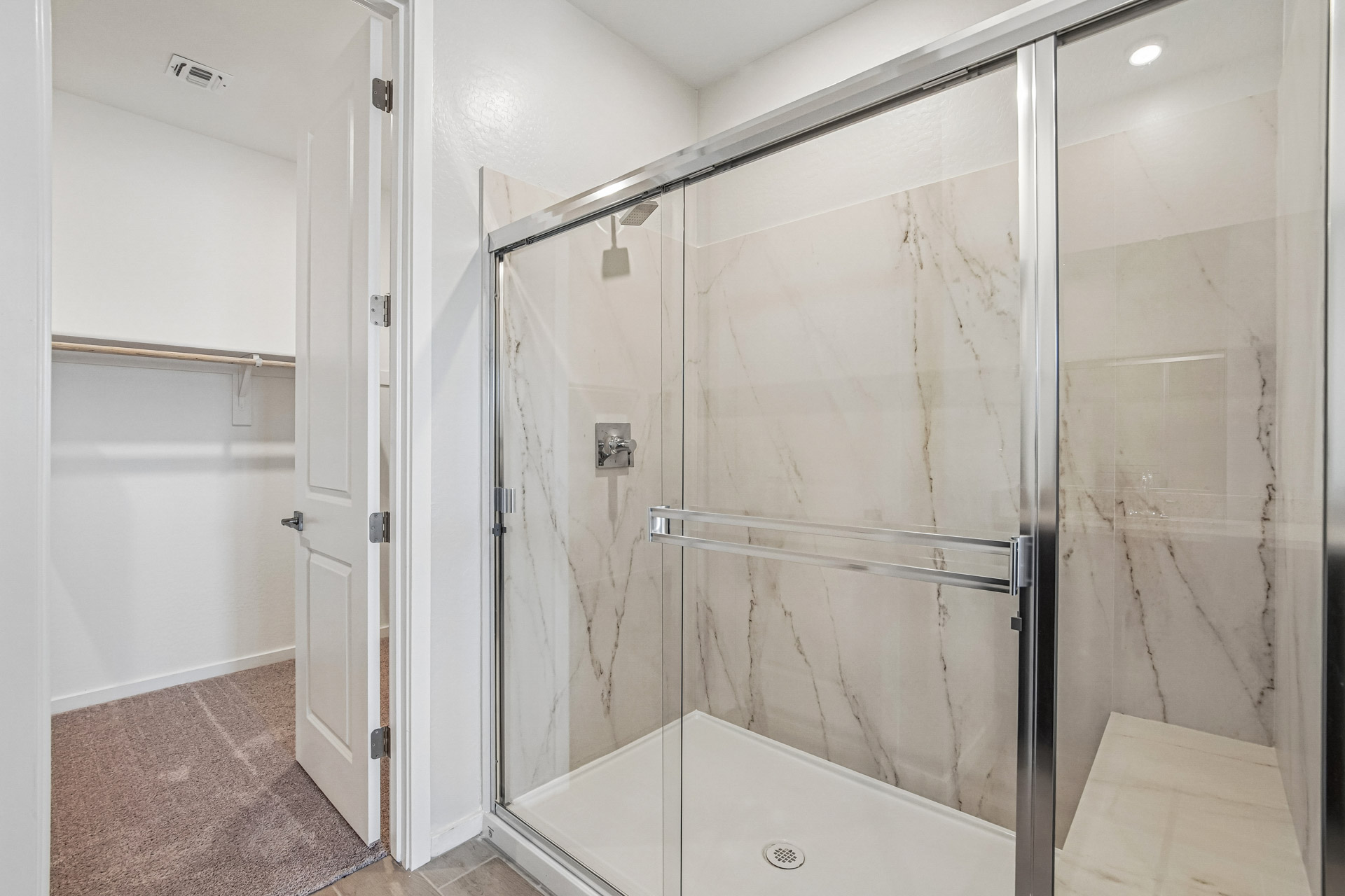 A bathroom with a shower unit.