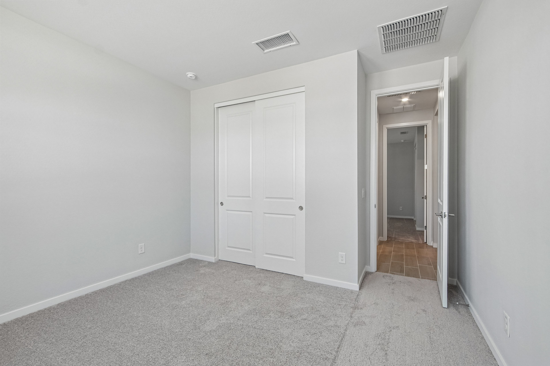 A hallway with white doors.