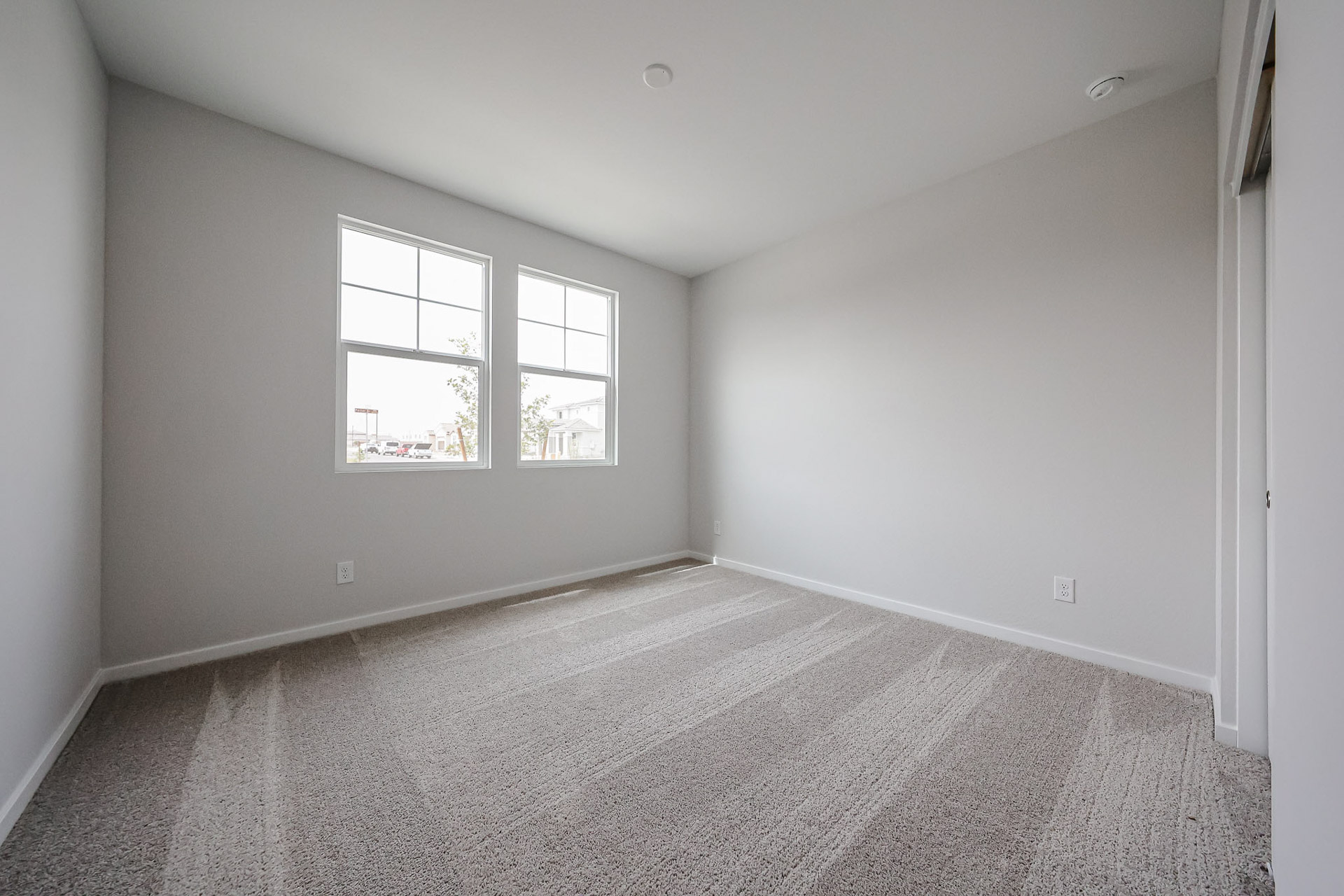 A room with a window and a carpet.