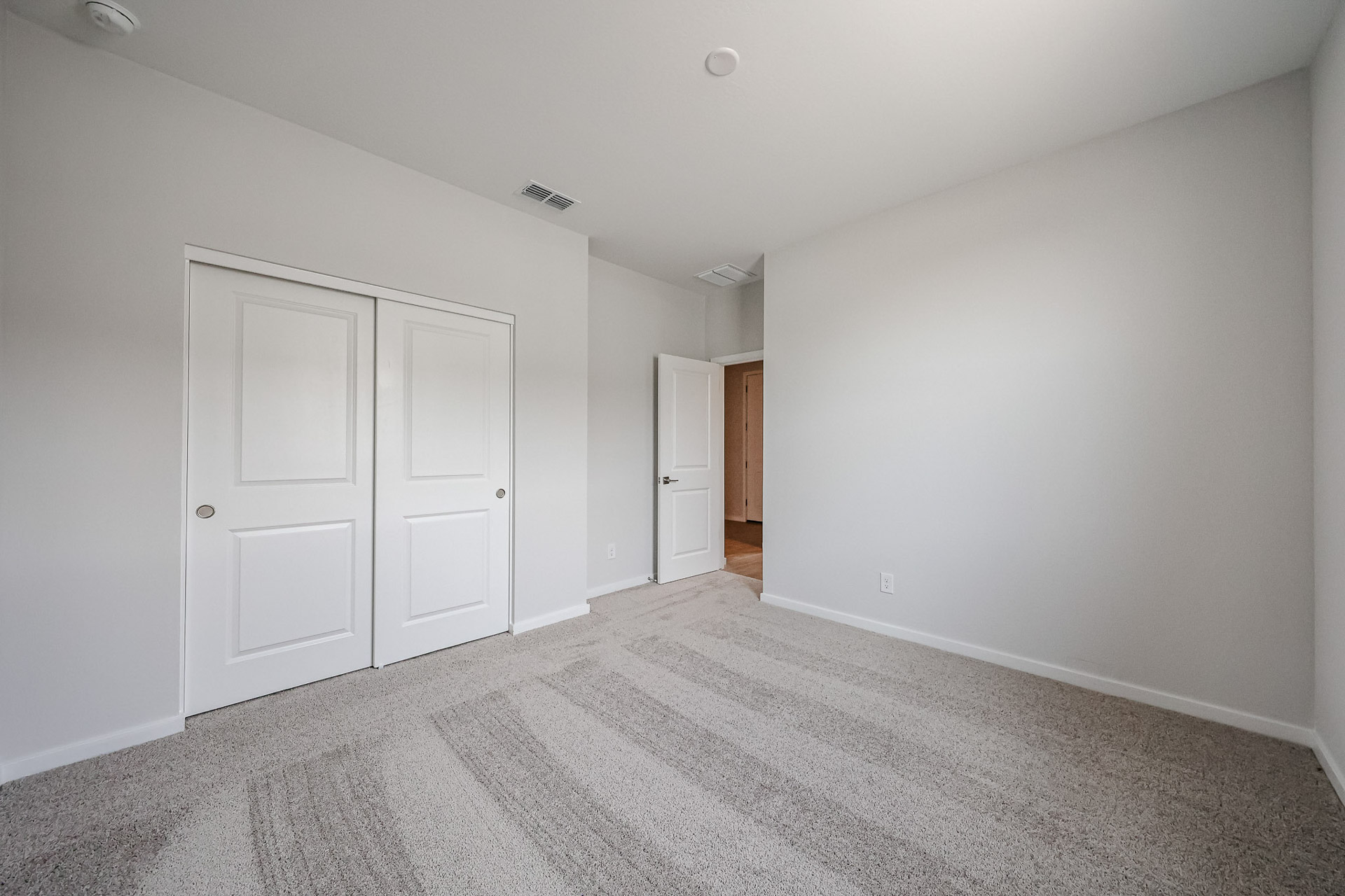 A hallway with white doors.