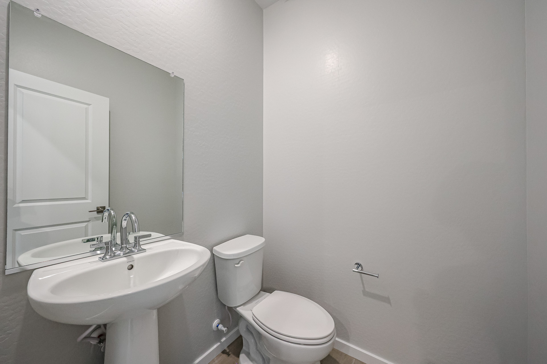 A bathroom with a sink and toilet.