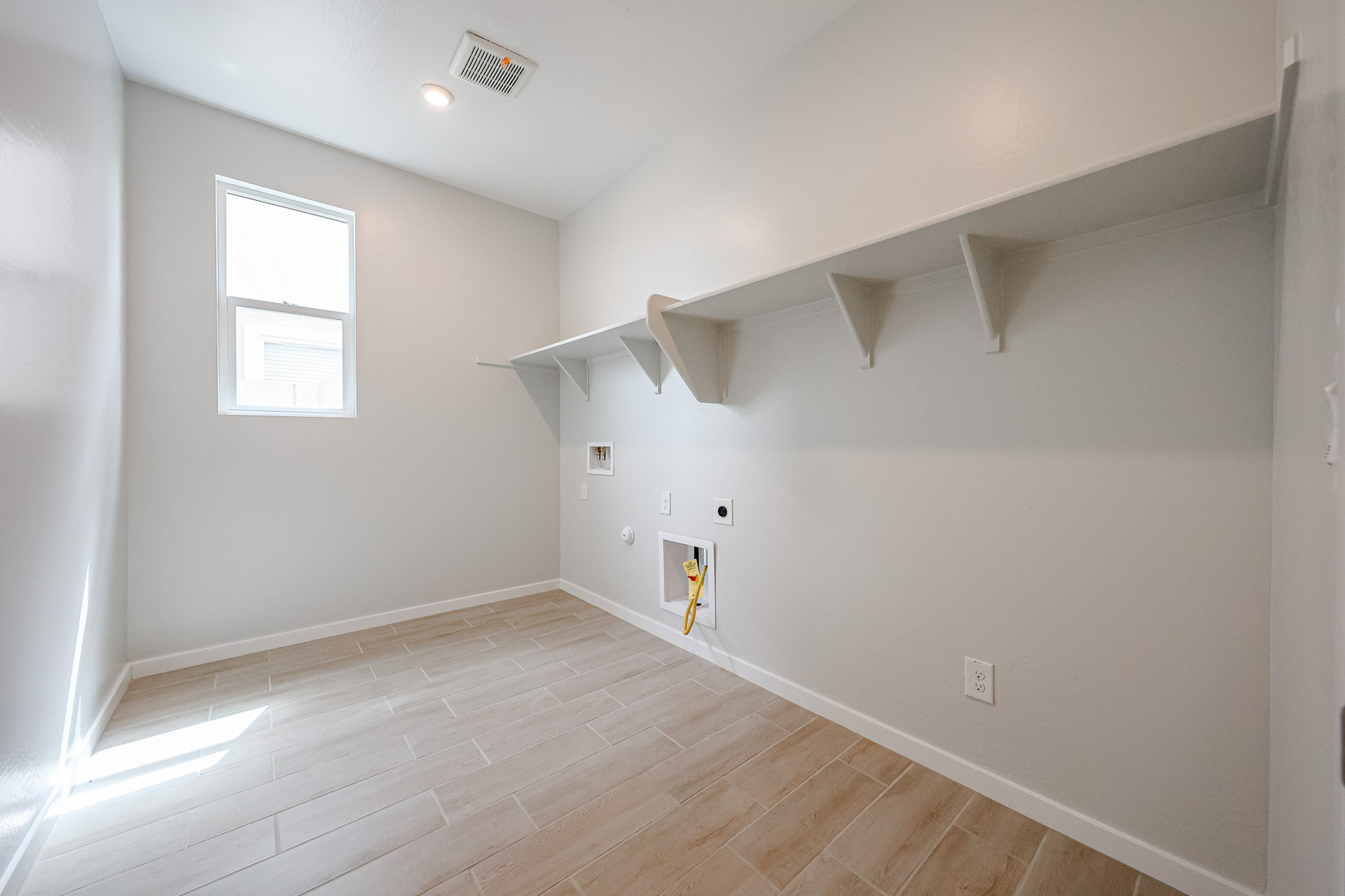A room with a wood floor and white walls.