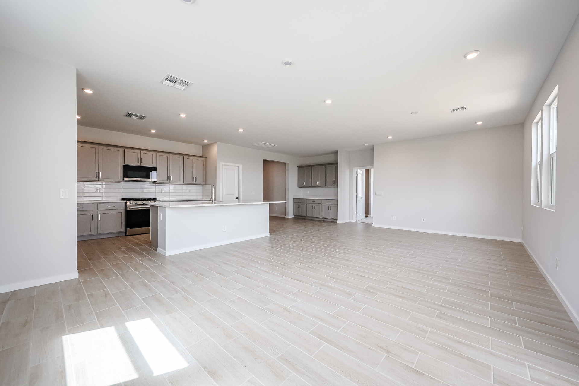 A large kitchen with wooden floors.