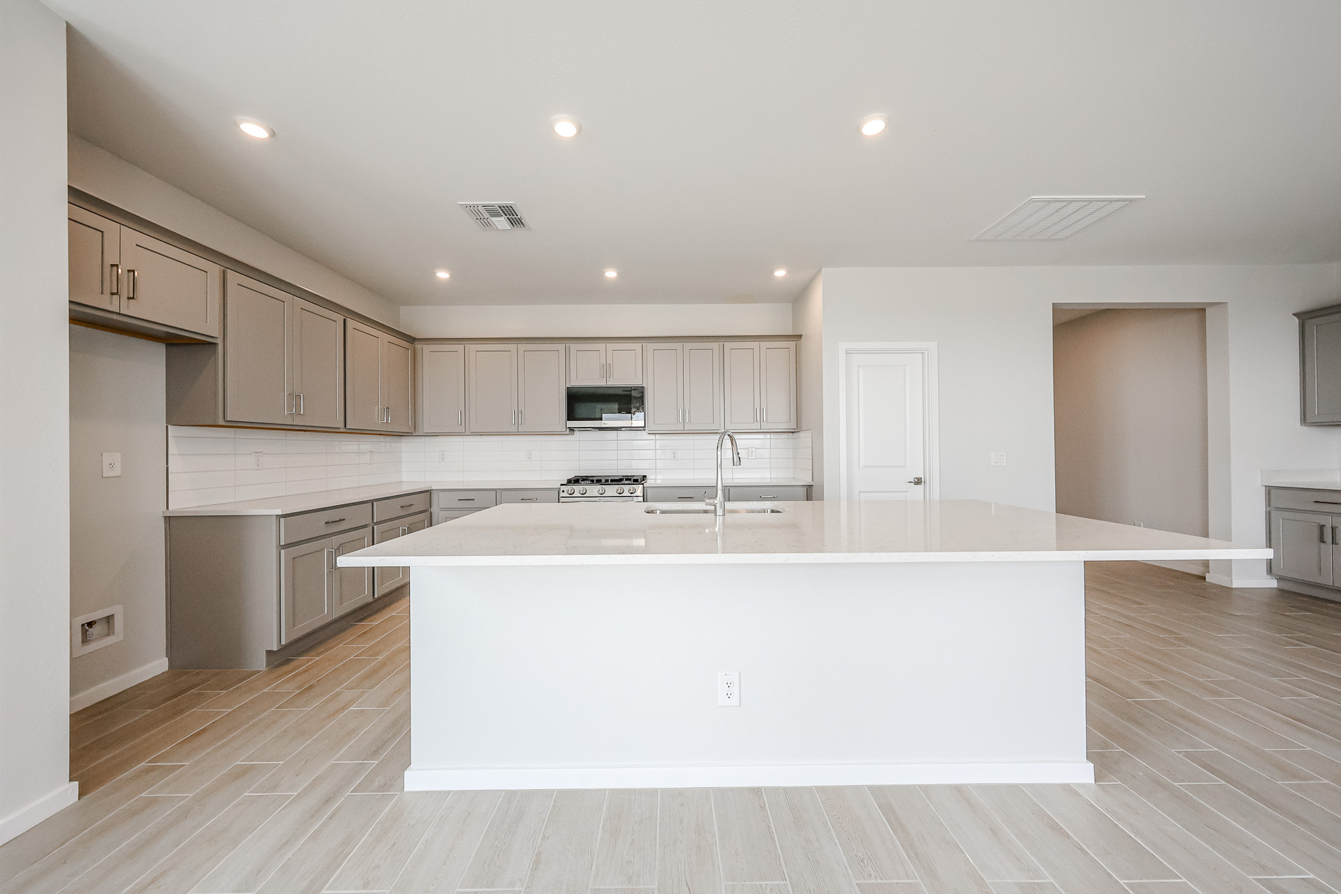 A kitchen with white cabinets.