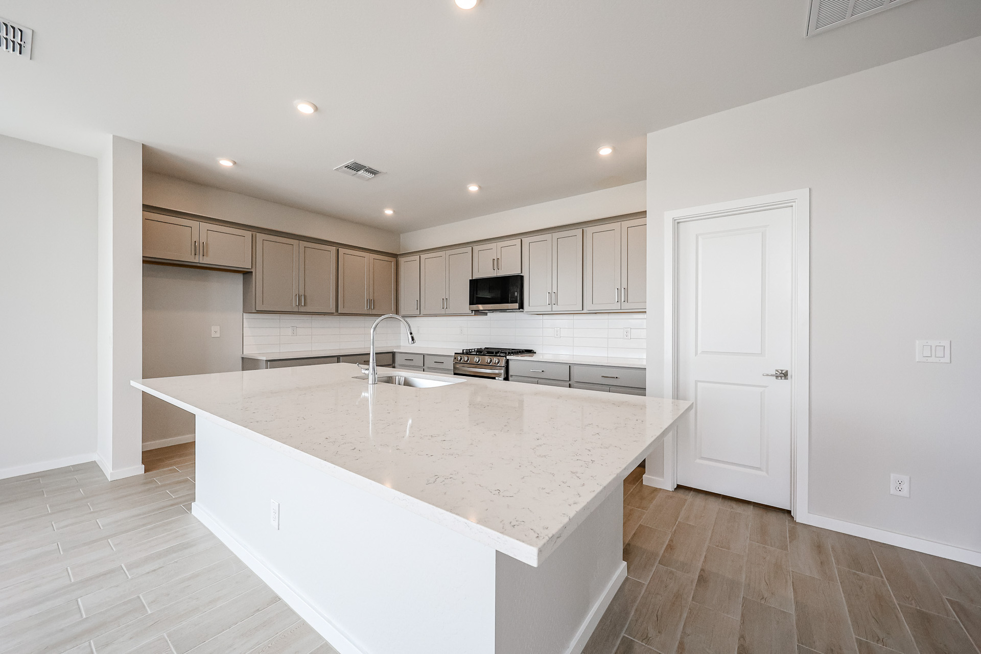 A kitchen with white cabinets.