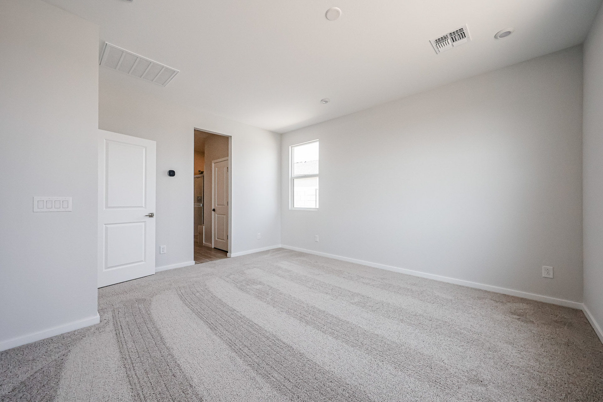 A room with white walls and a carpeted floor.