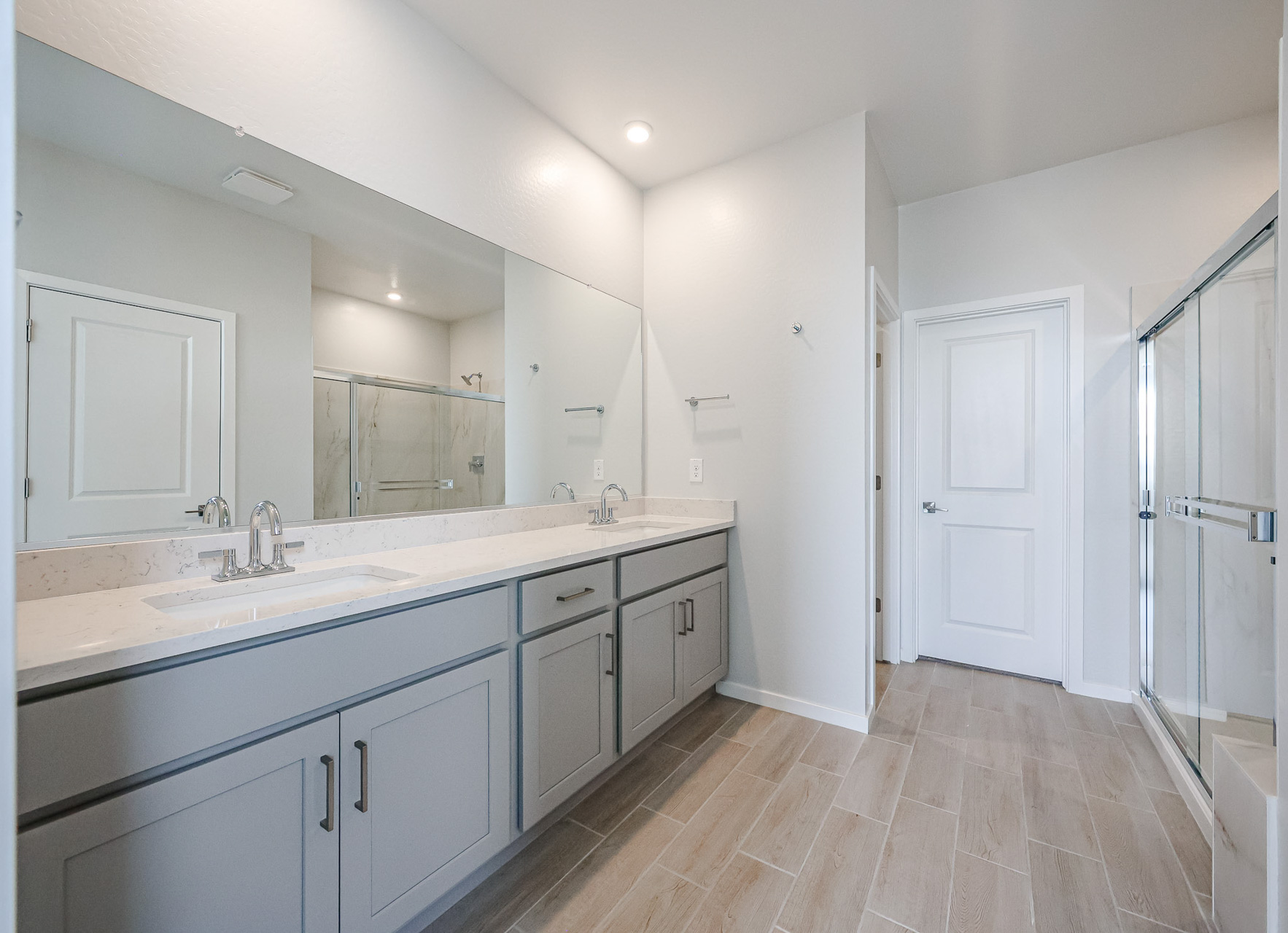 A bathroom with white cabinets.