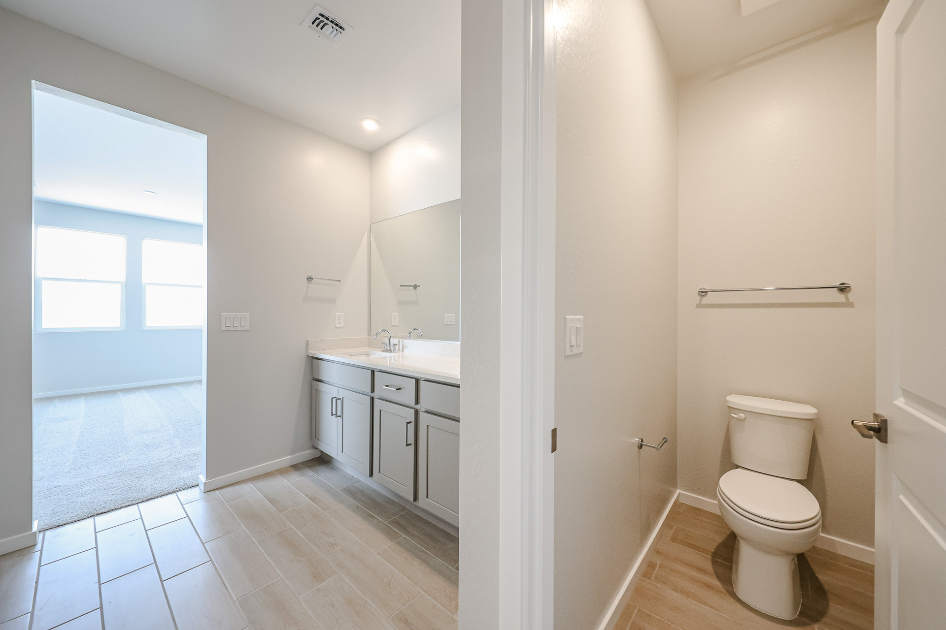 A bathroom with a toilet and sink.