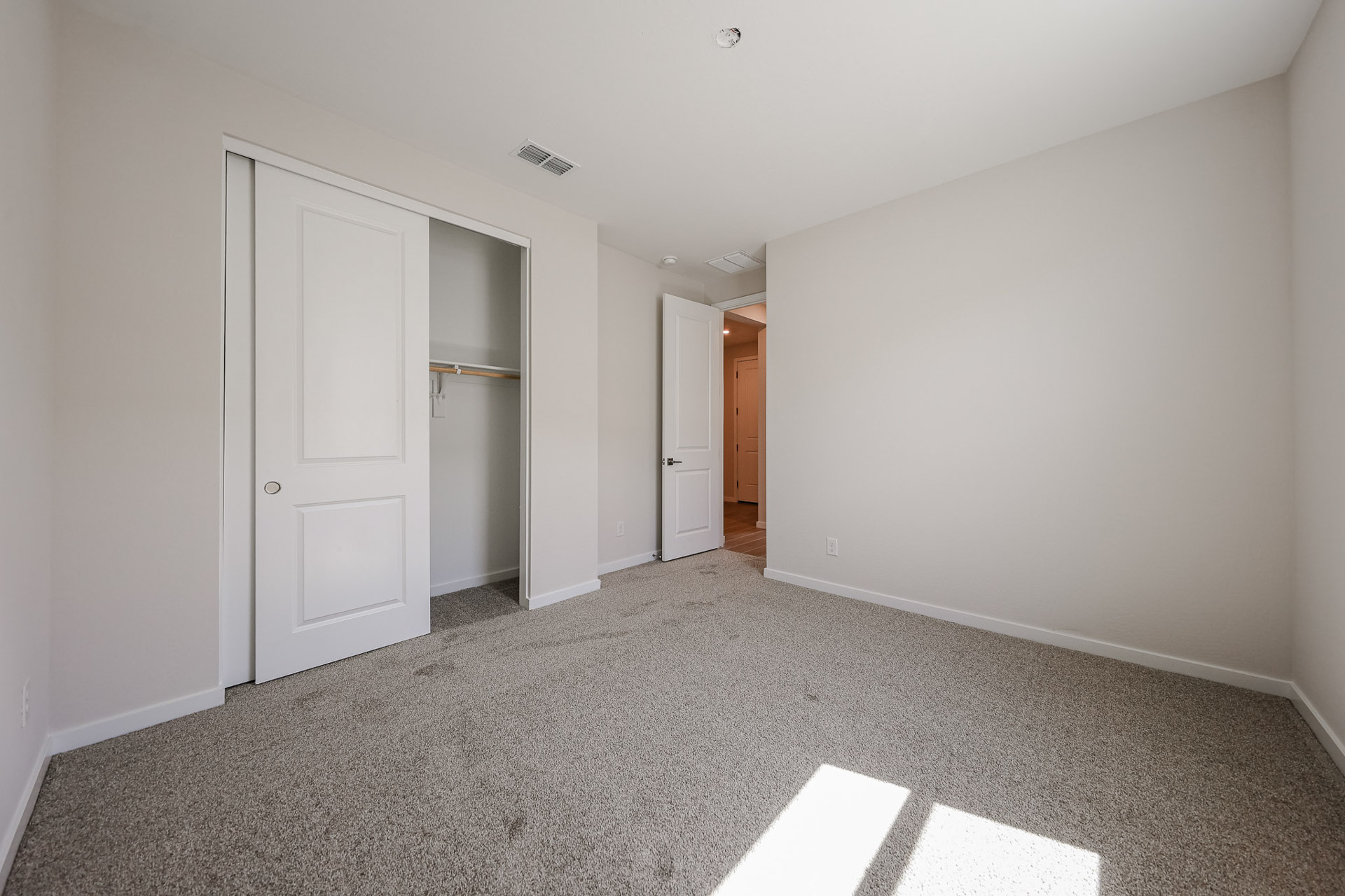A hallway with white doors.