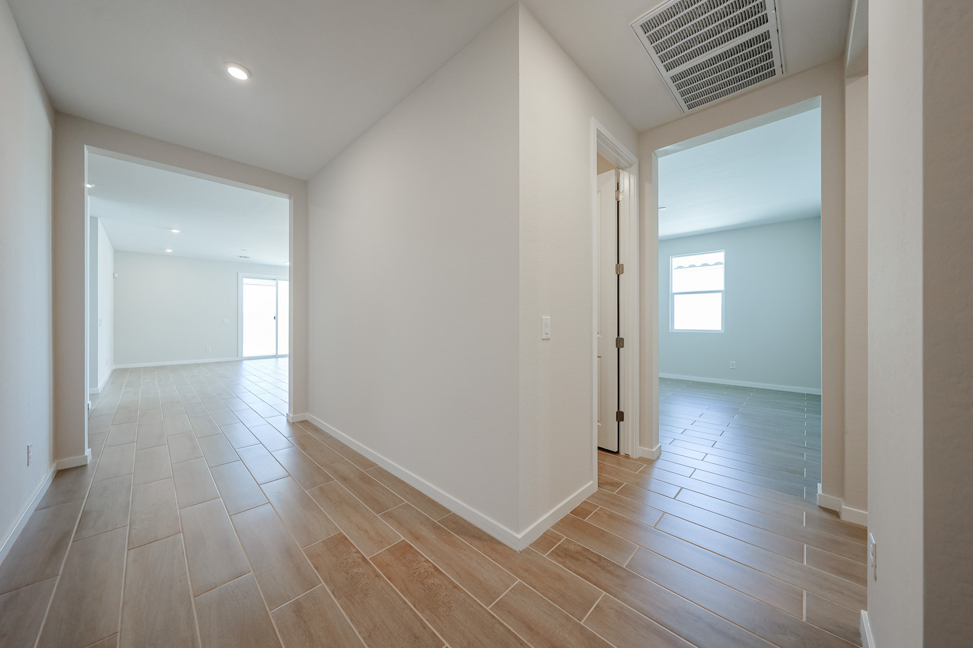 A room with a wood floor and white walls.