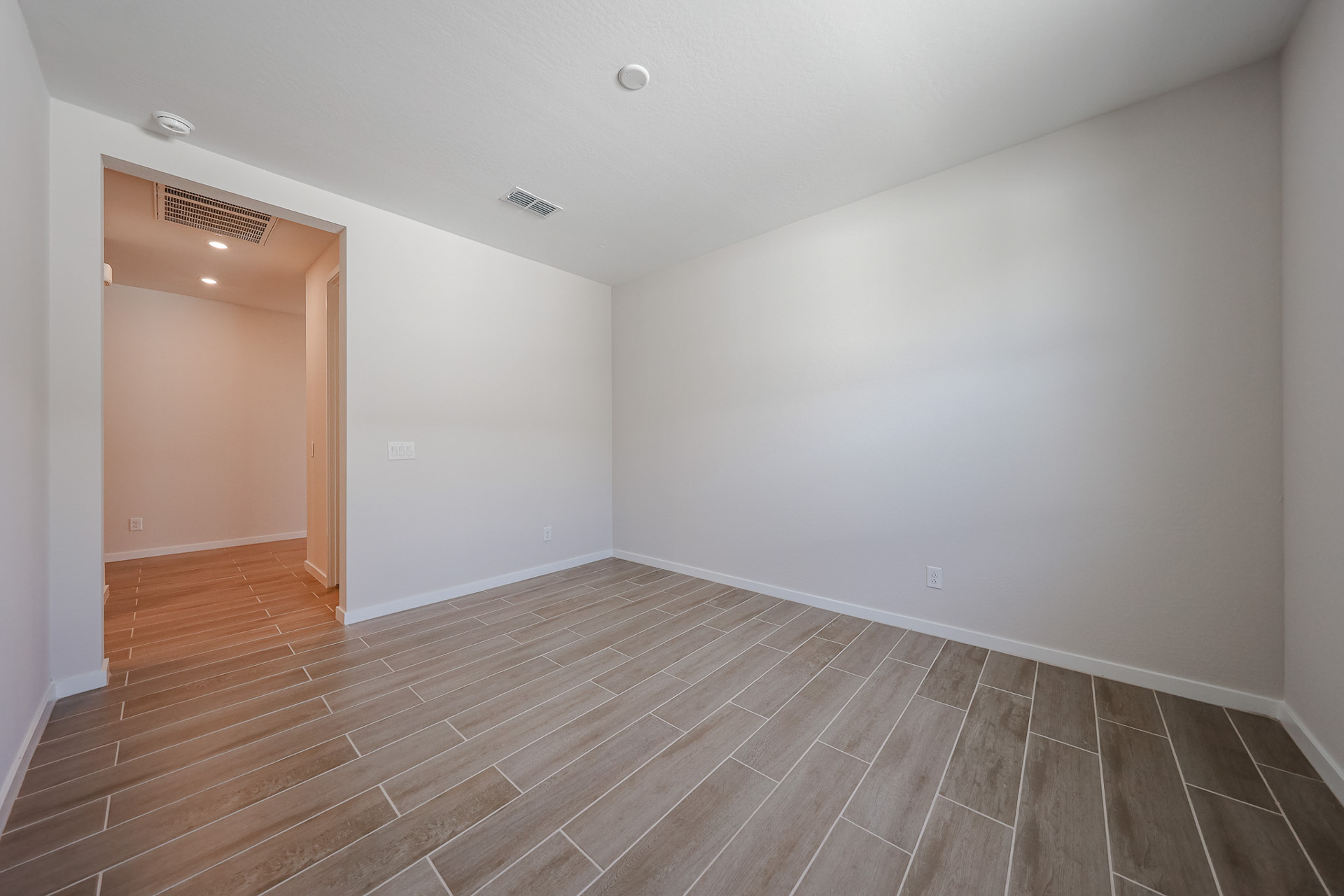A room with a wood floor and a wood floor.