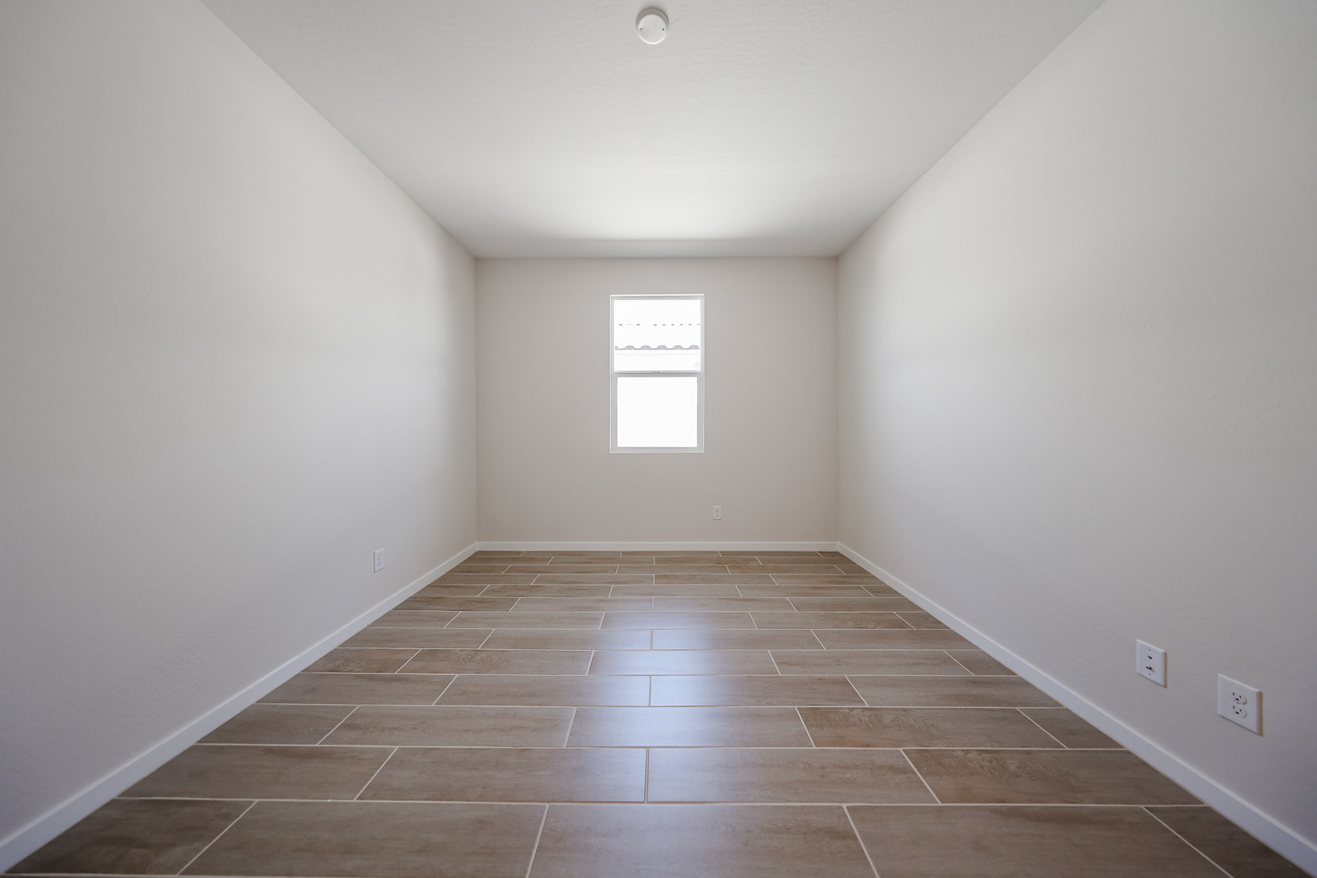 A room with a tile floor and a window.