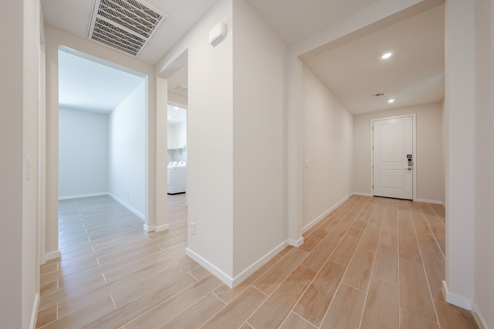 A room with a wood floor and white walls.