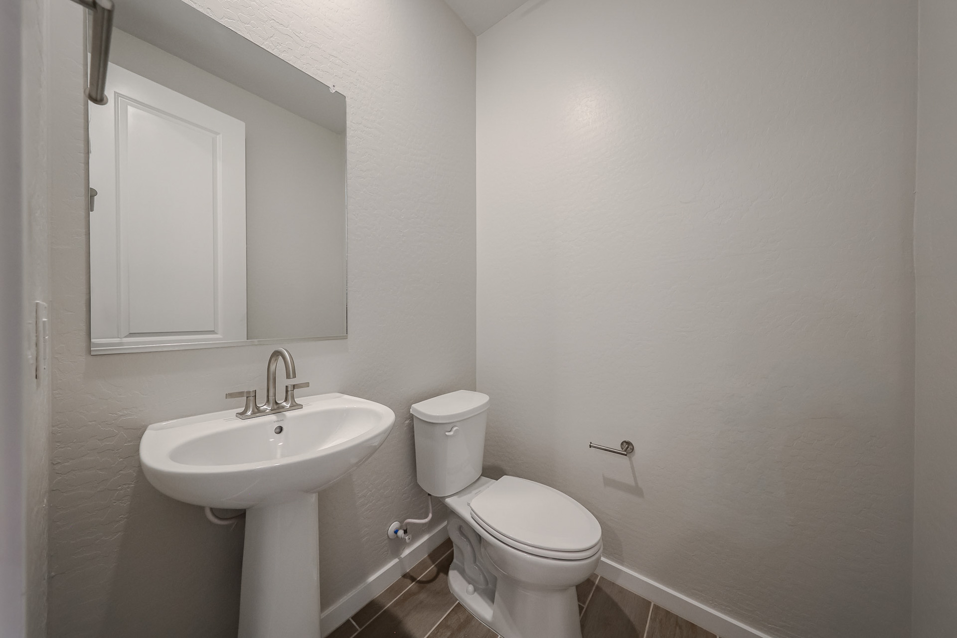 A bathroom with a toilet and sink.