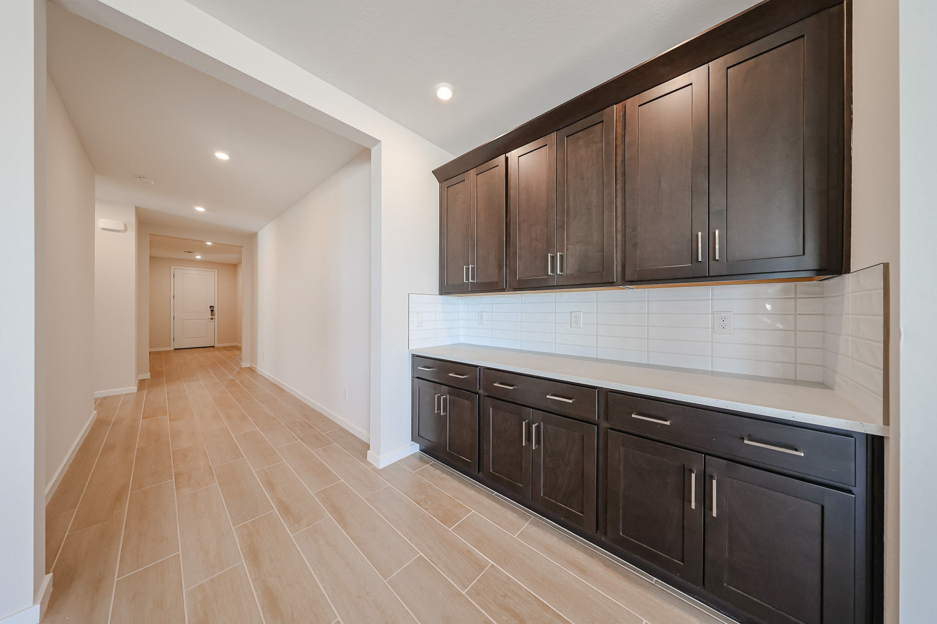 A kitchen with black cabinets.