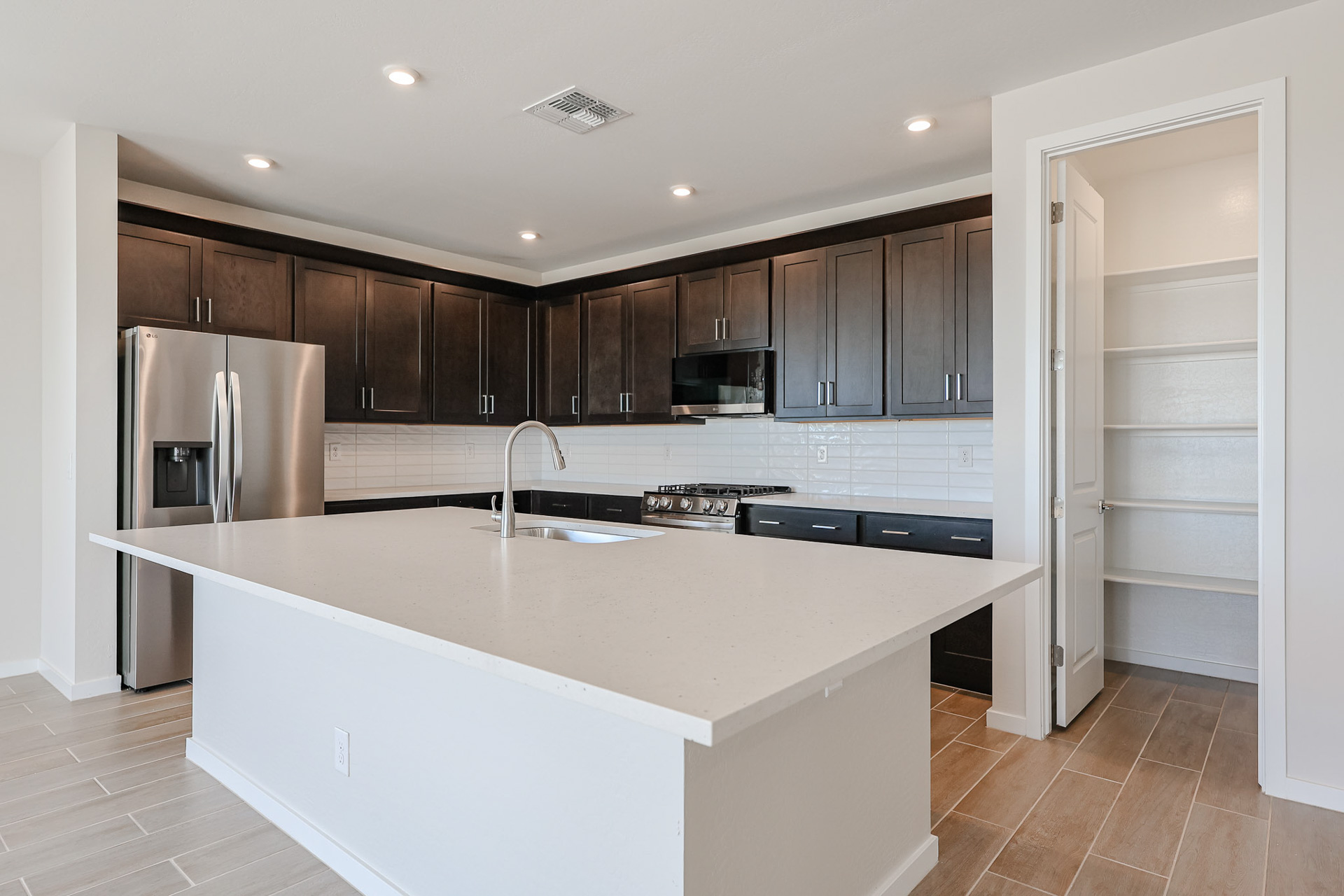 A kitchen with black cabinets.