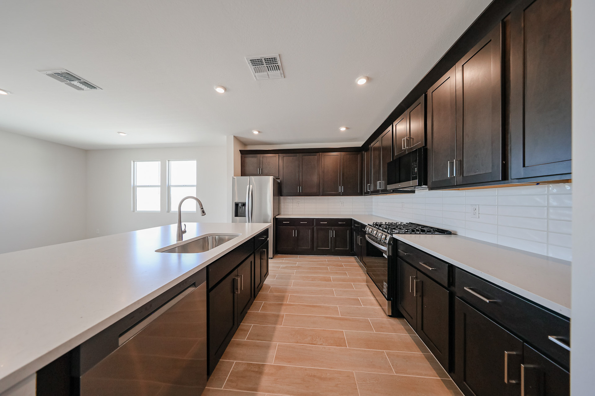 A kitchen with black cabinets.
