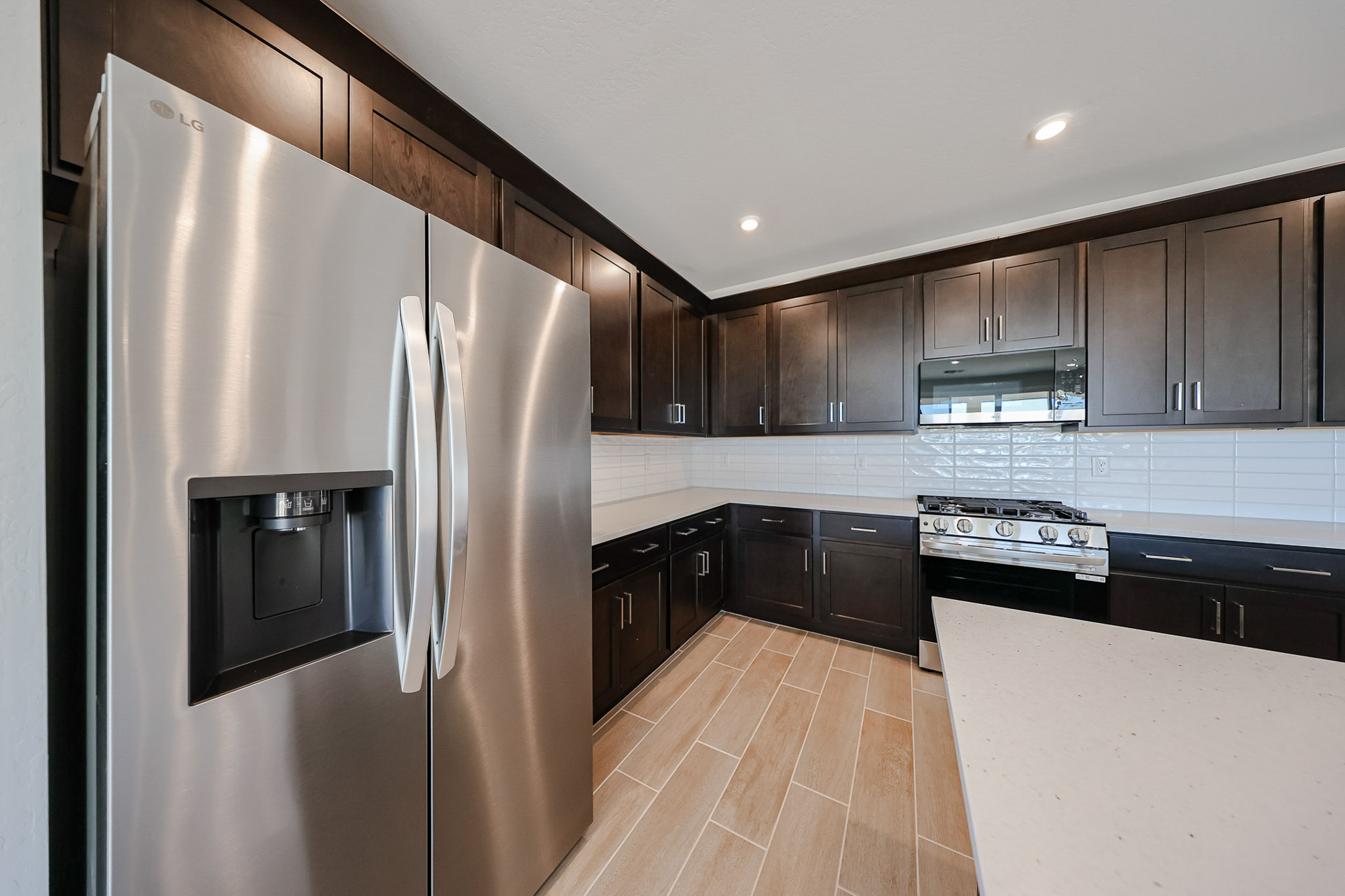 A kitchen with black cabinets.