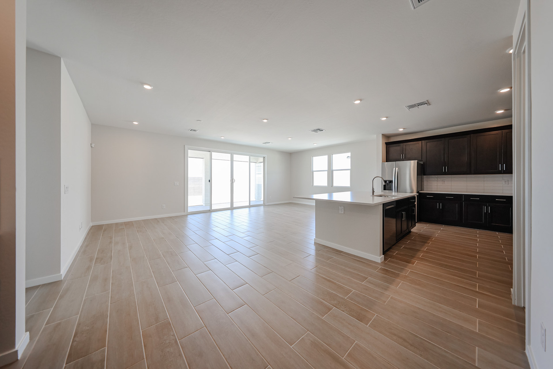 A large kitchen with wood floors.