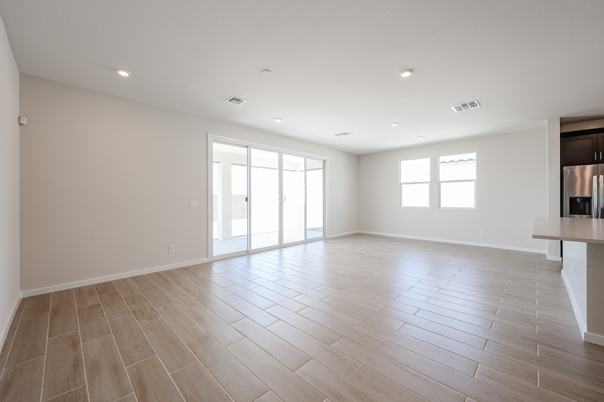 A large empty room with a wood floor and white walls.