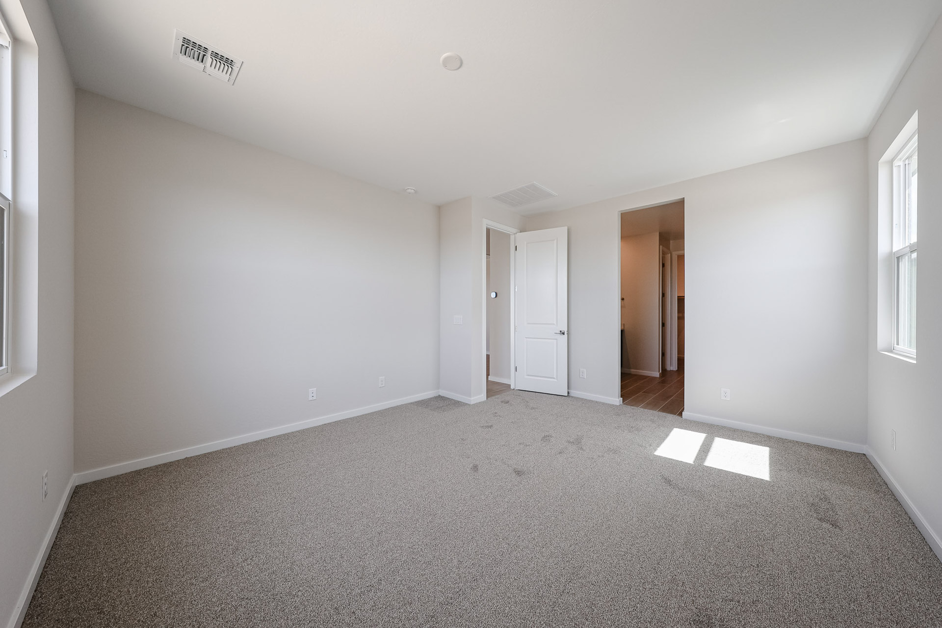 A hallway with white doors.