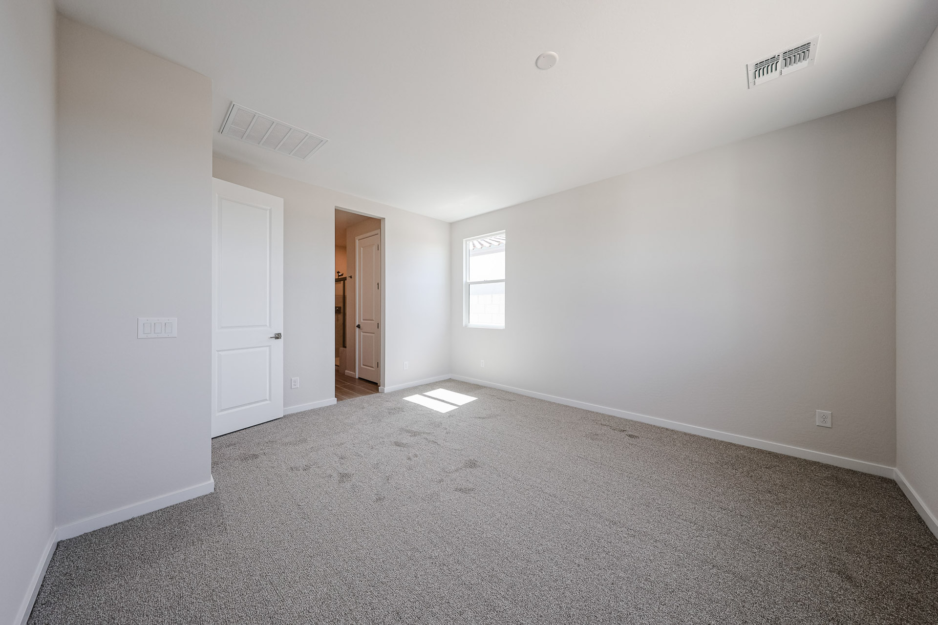 A hallway with white walls.