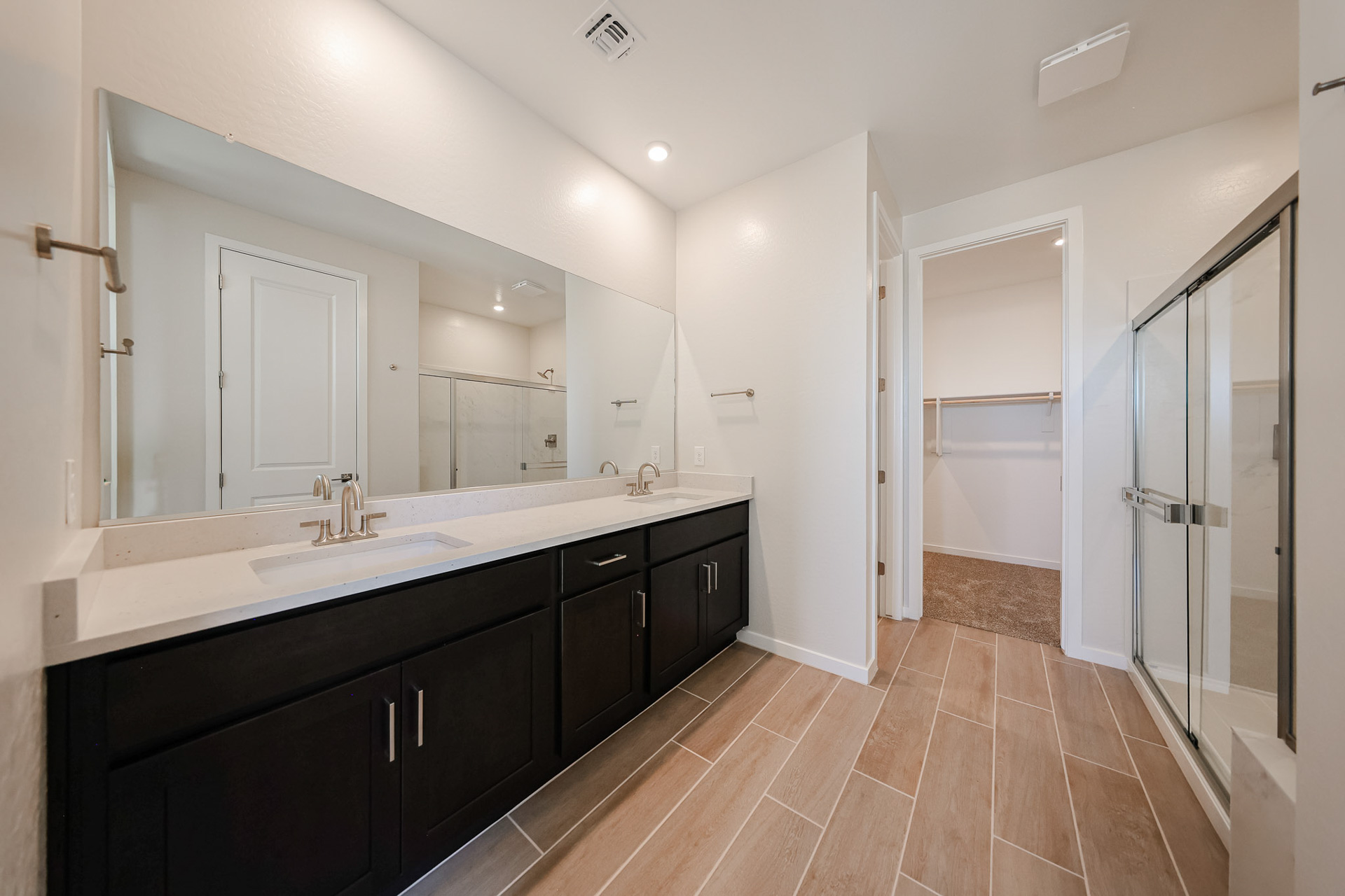 A bathroom with a large mirror.
