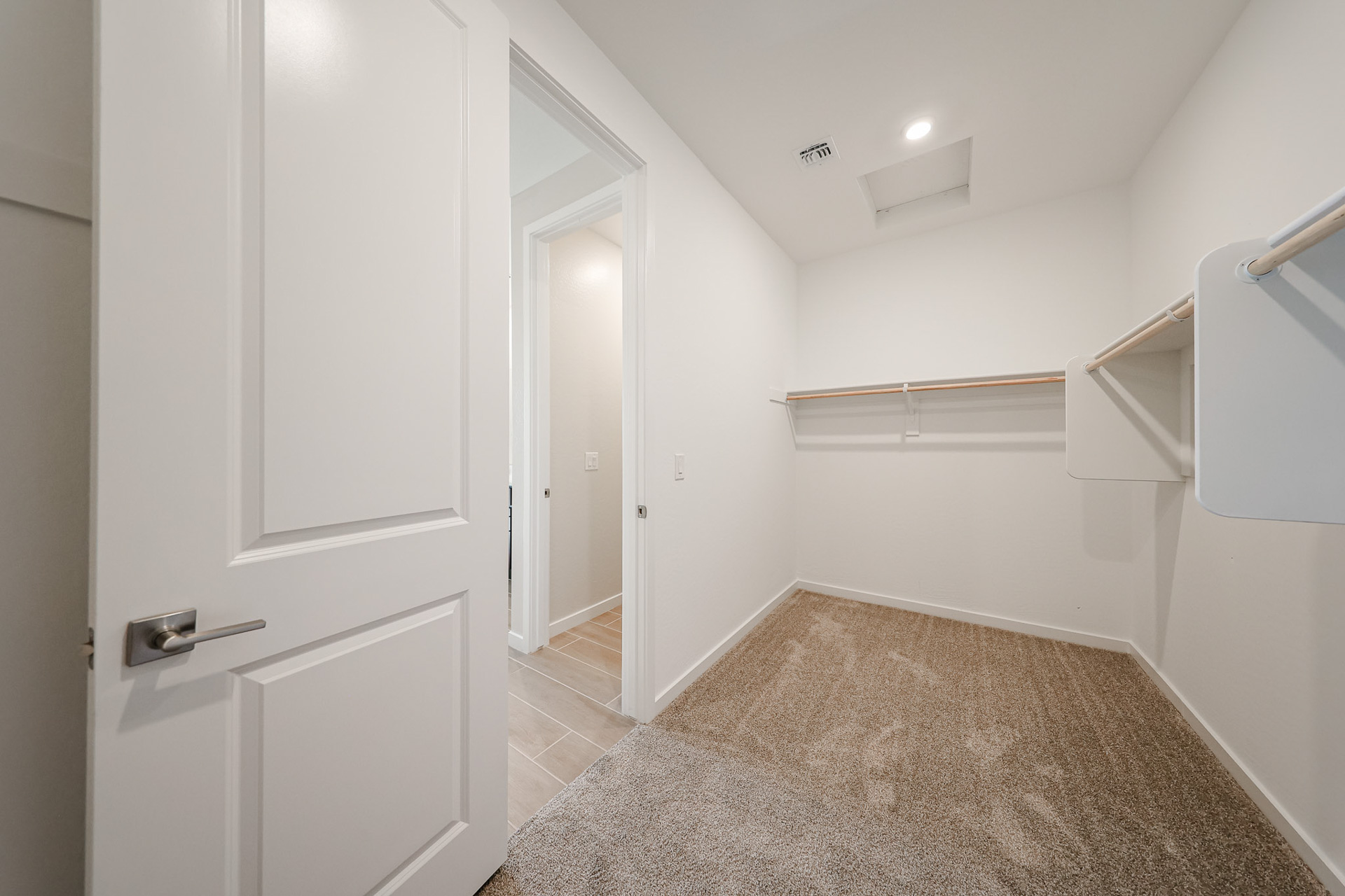 A hallway with white doors.