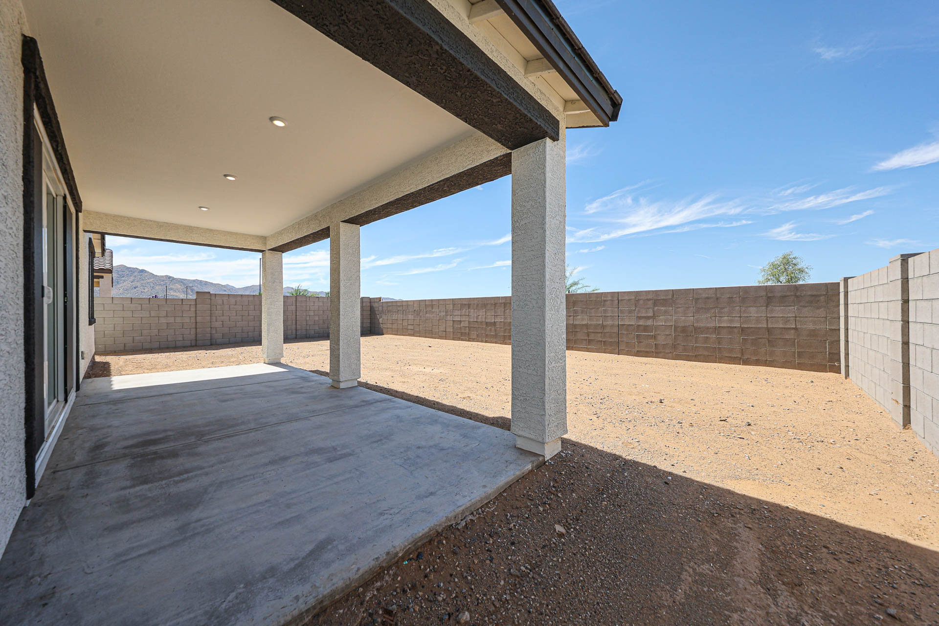 A concrete patio with a covered patio.