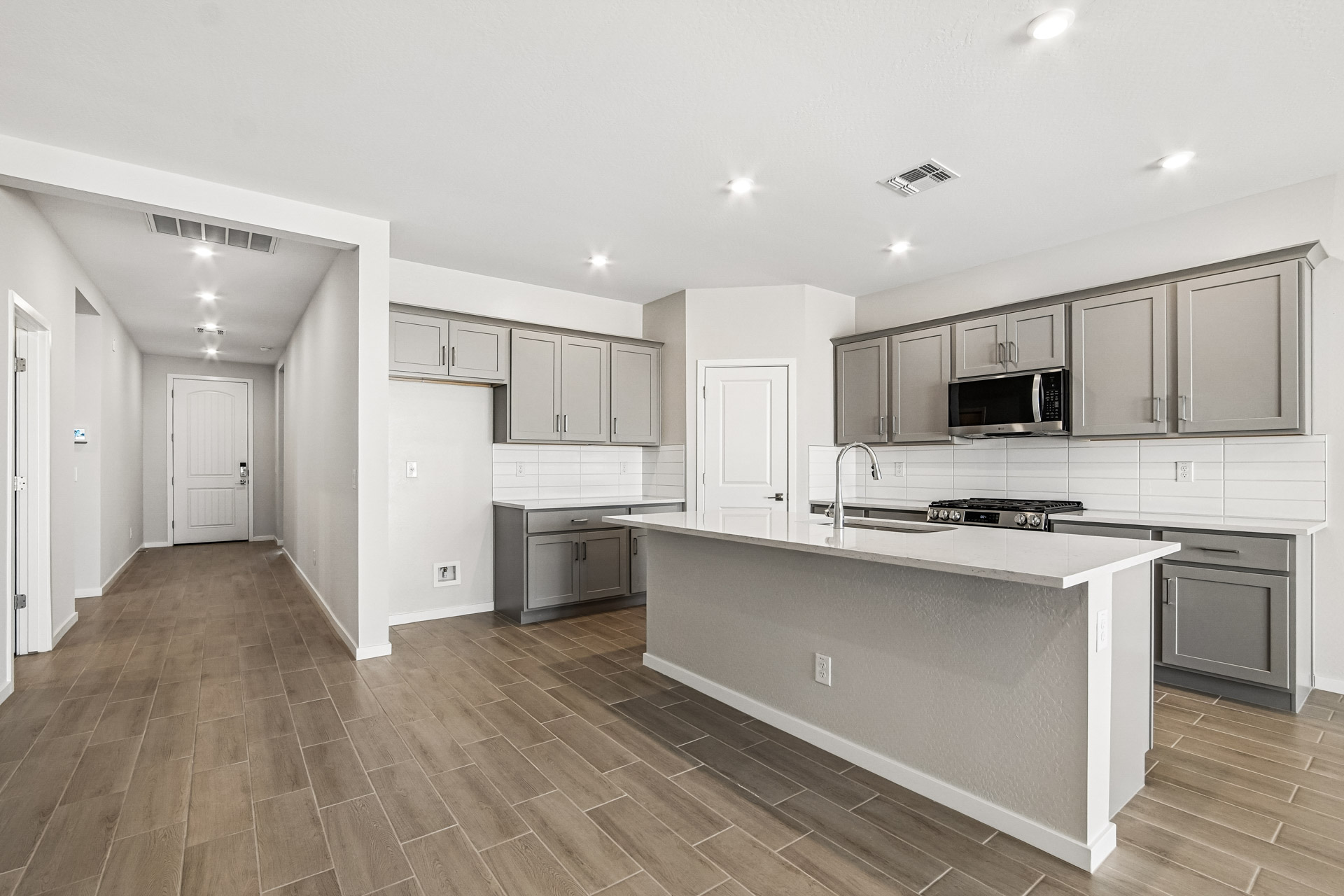 A kitchen with white cabinets.