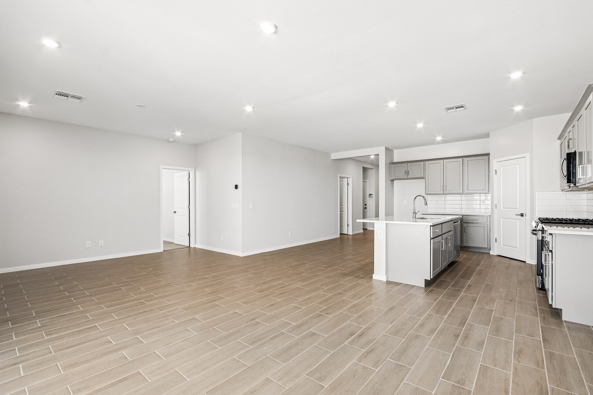 A large kitchen with white cabinets.