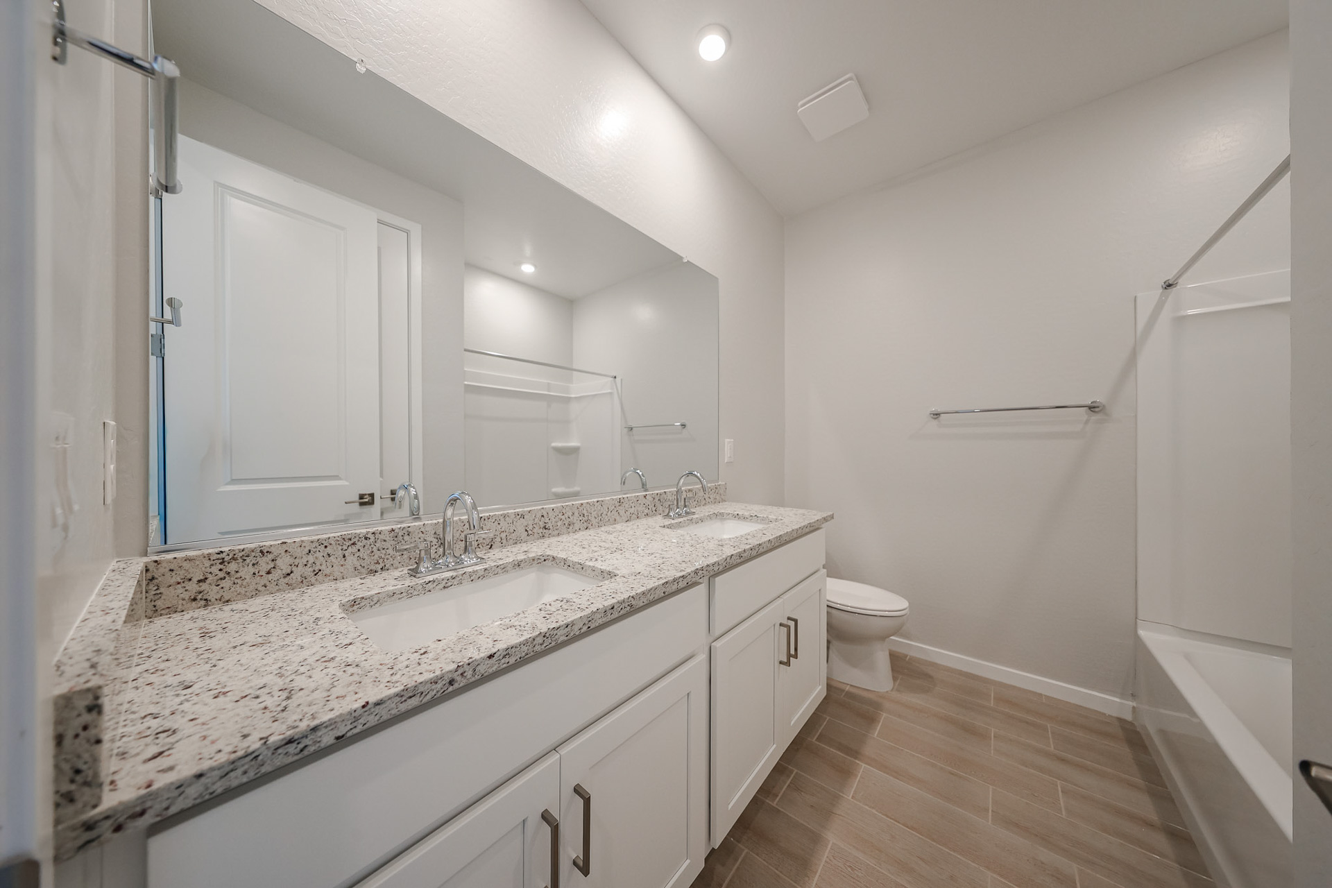 A bathroom with a marble countertop.
