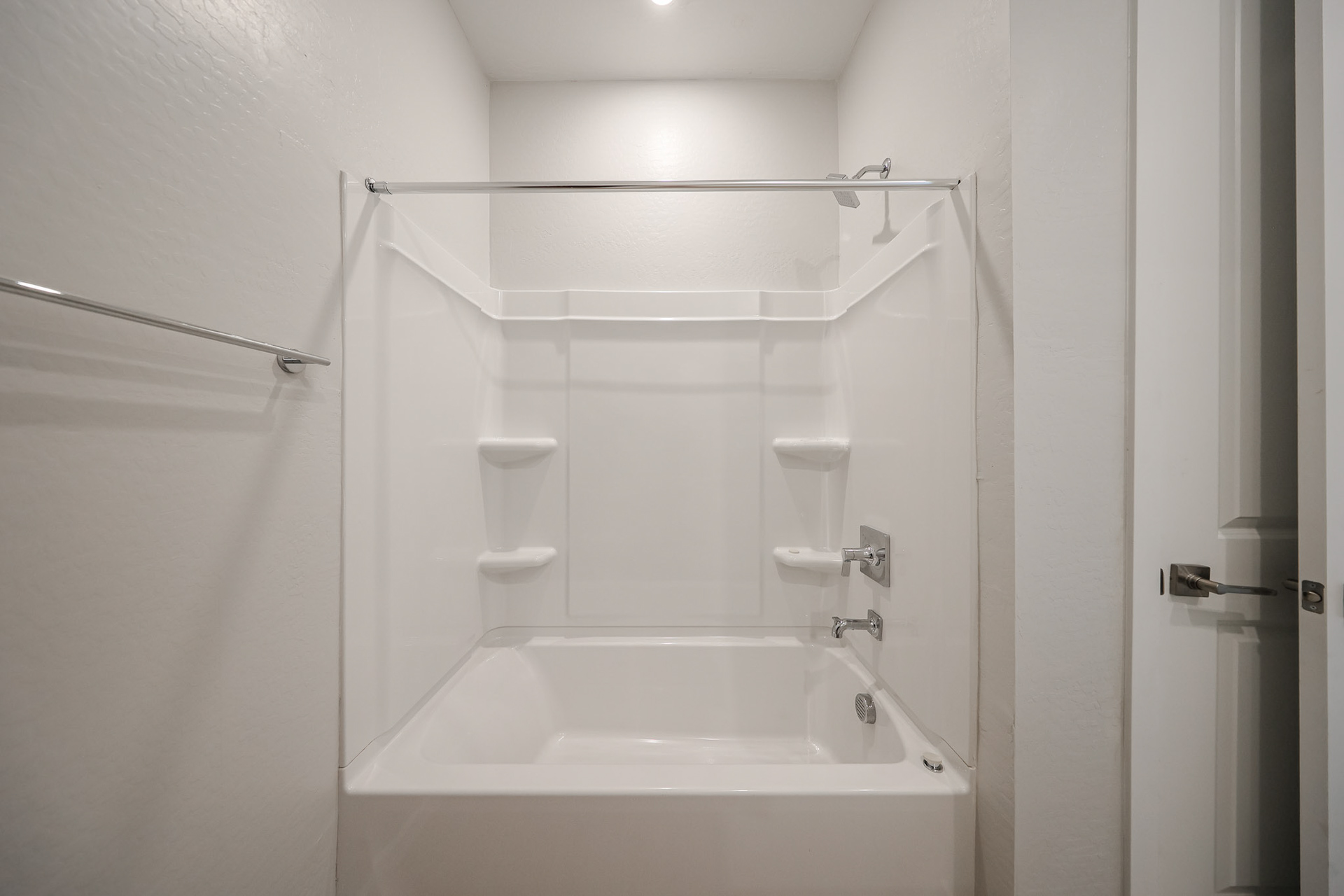 A bathroom with a bathtub and toilet.